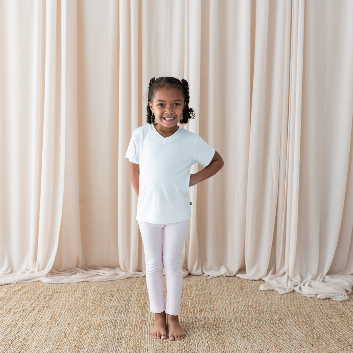 Girl wearing Kyte Baby Toddler Leggings in Sakura