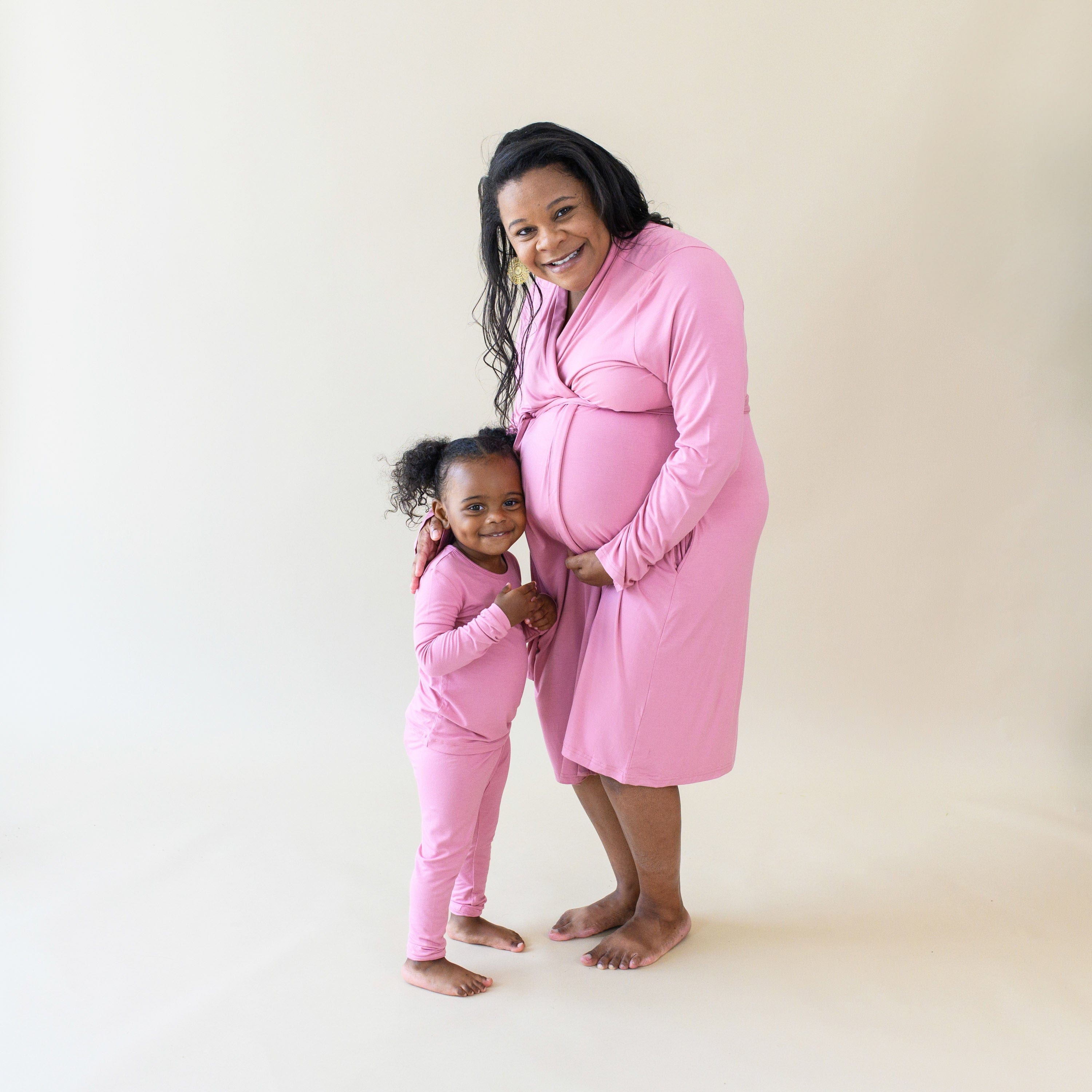 Toddler wearing Kyte Baby bamboo Long Sleeve Pajamas in Apple Blossom with mom in matching robe
