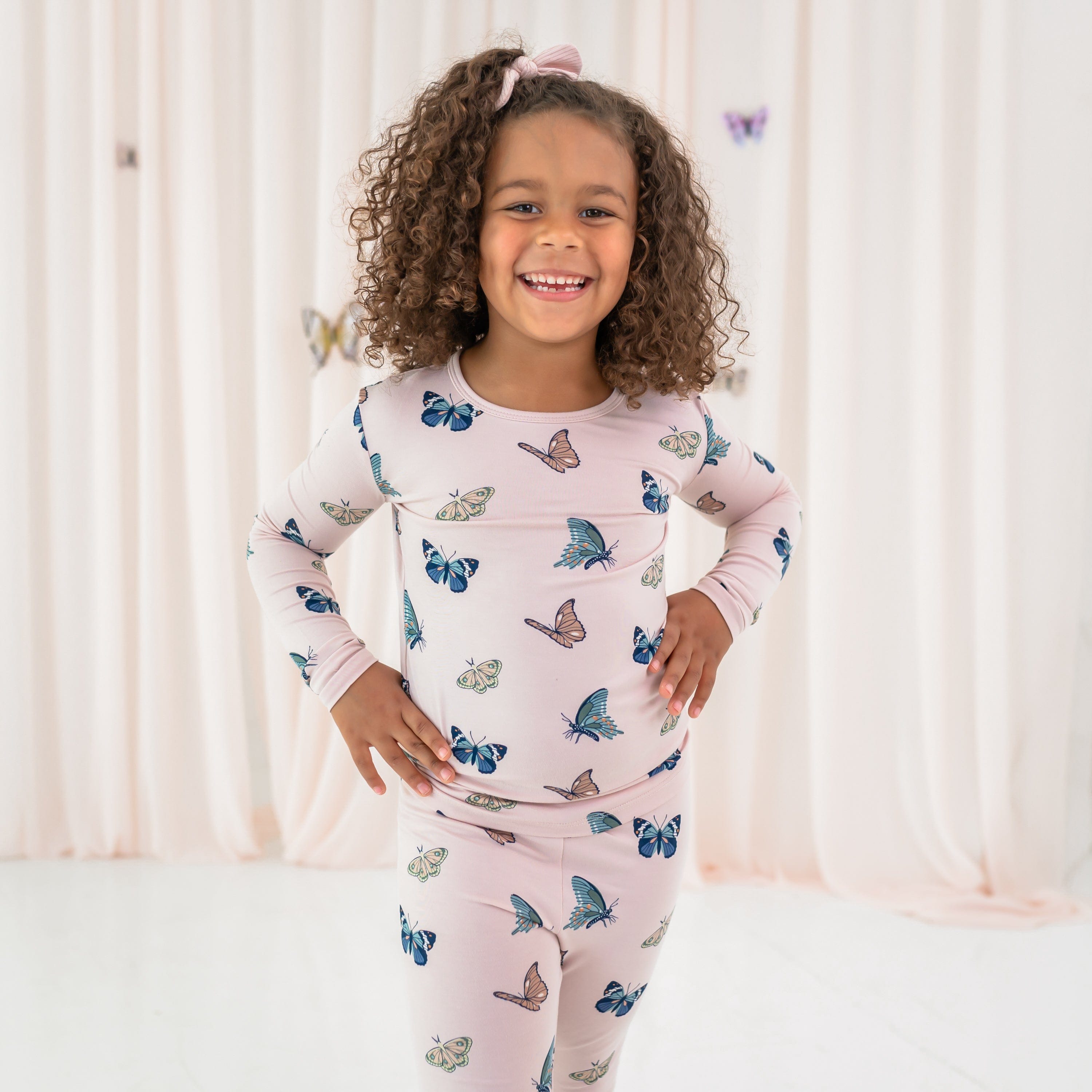 Toddler wearing pink bamboo Long Sleeve Pajamas in Blush Butterfly