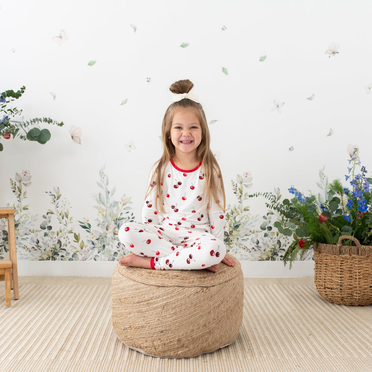 Child wearing Kyte Baby Long Sleeve Pajamas in Cherry