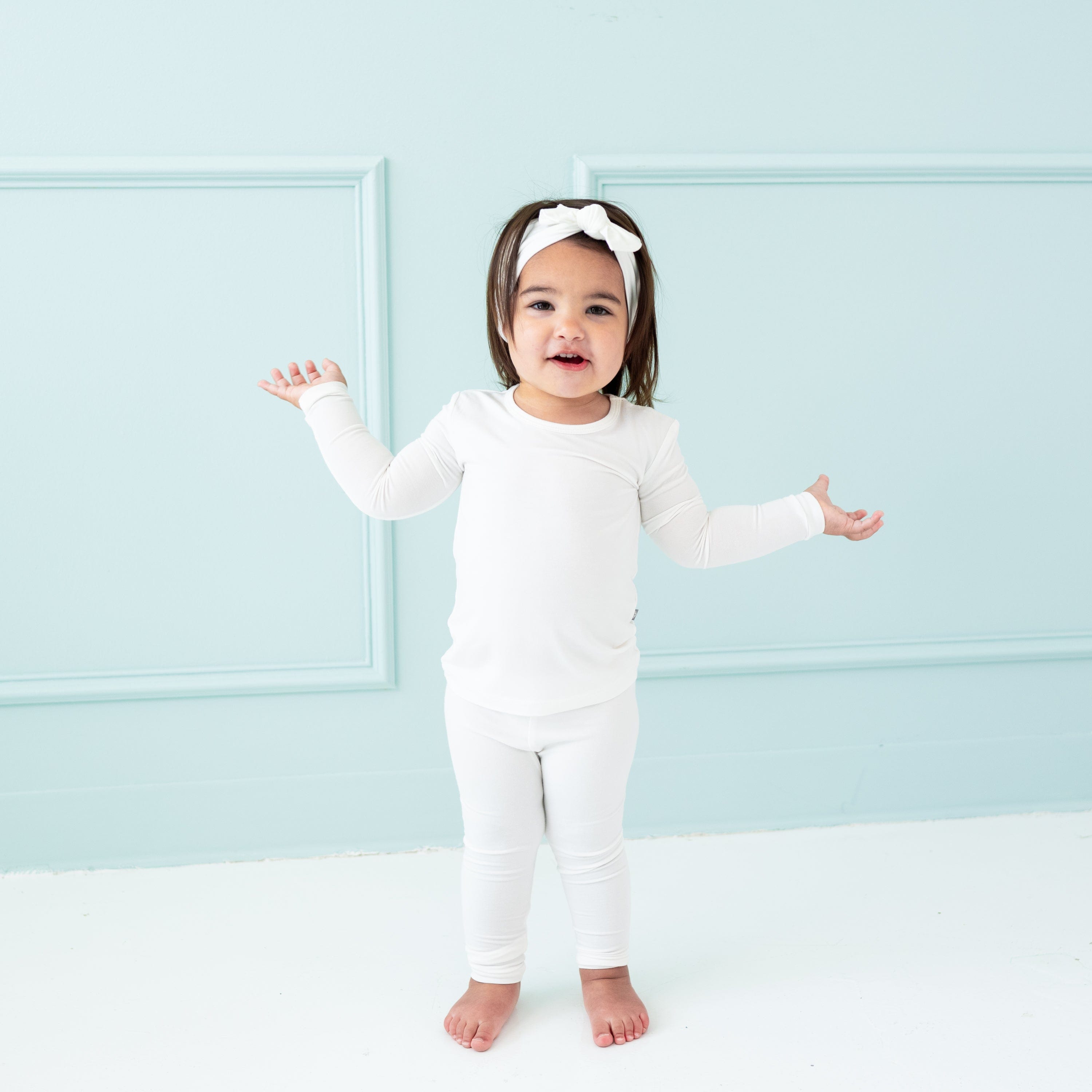 Toddler wearing Long Sleeve Pajamas in Cloud and matching bow headband