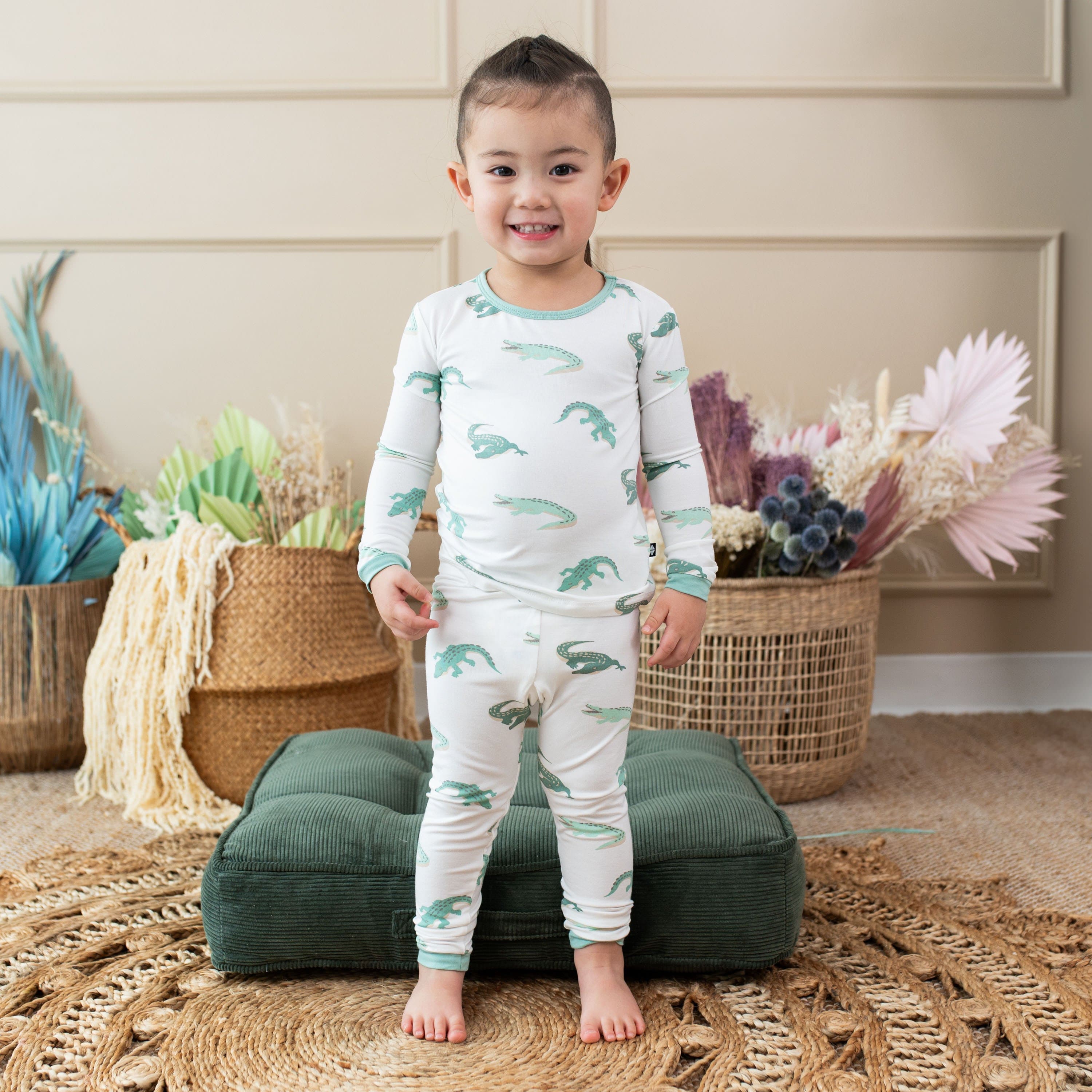 Child wearing Kyte Baby Long Sleeve Pajamas in Crocodile