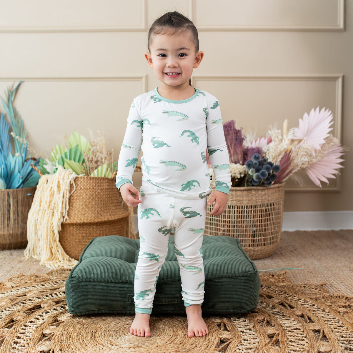 Child wearing Kyte Baby Long Sleeve Pajamas in Crocodile