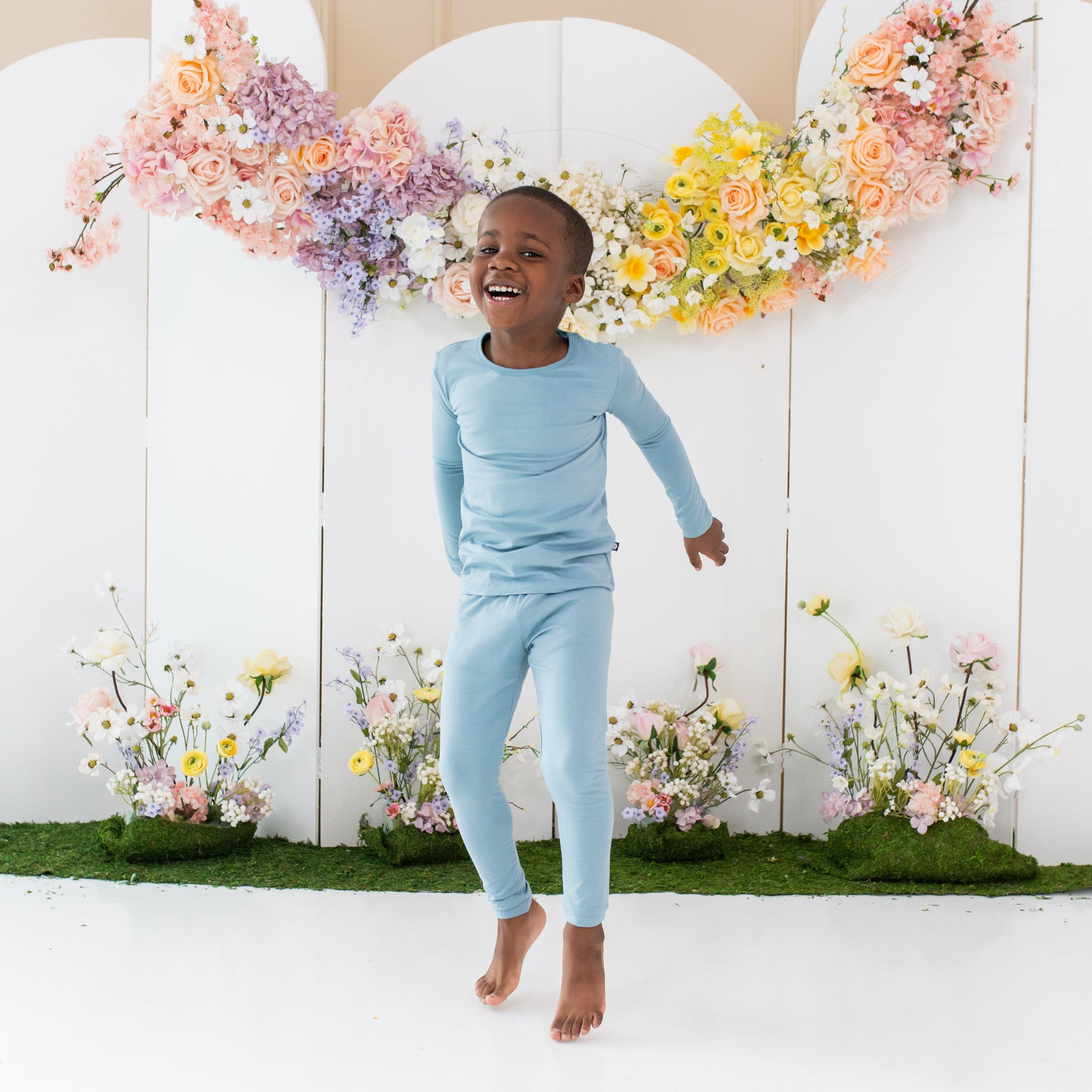 Toddler wearing Kyte Baby Long Sleeve Pajamas in Dusty Blue