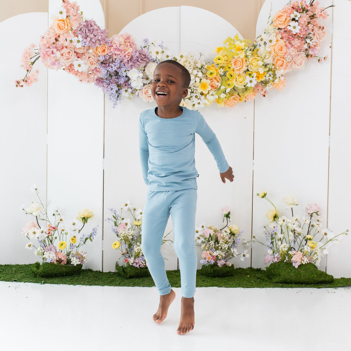 Toddler wearing Kyte Baby Long Sleeve Pajamas in Dusty Blue