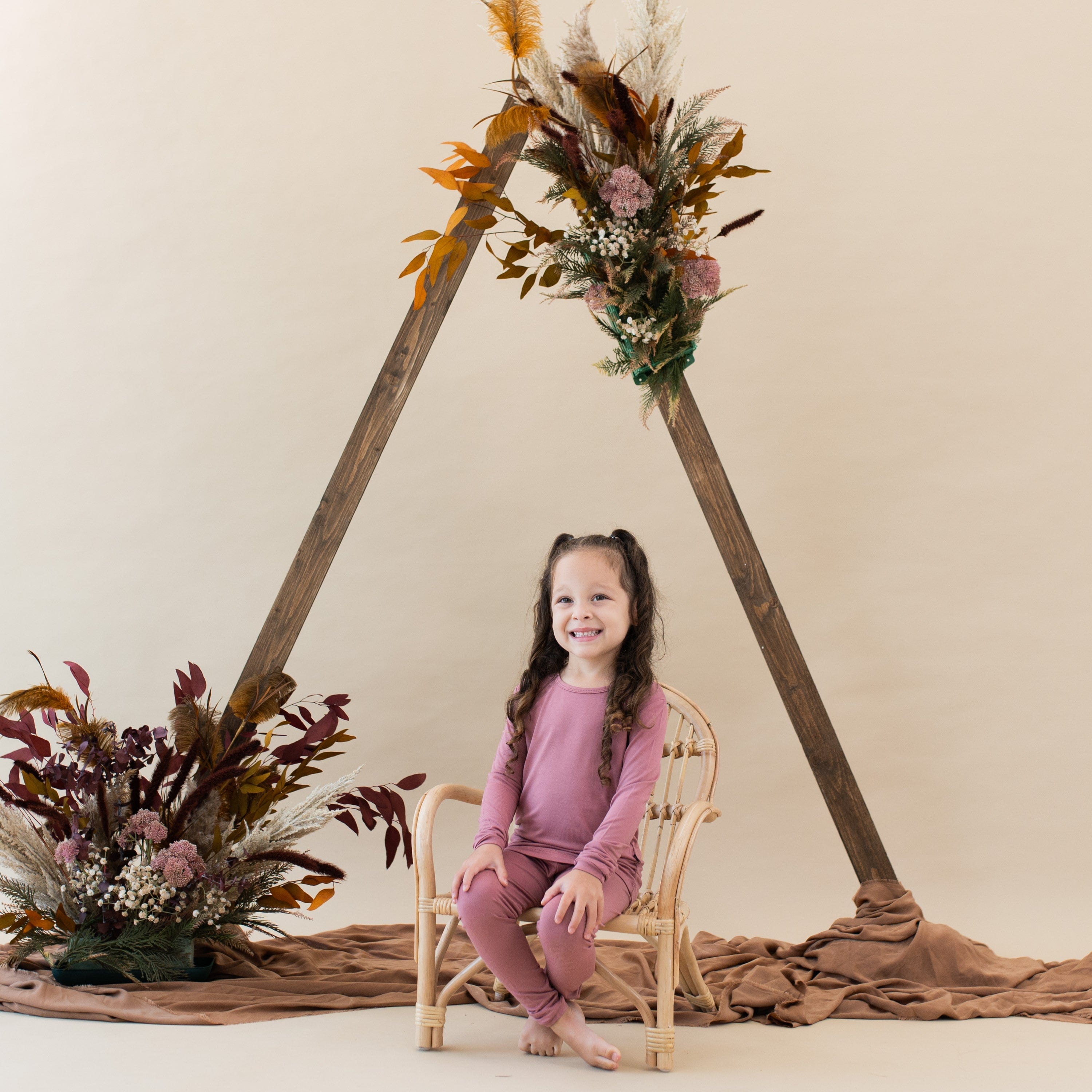 Toddler wearing Kyte Baby bamboo Long Sleeve Pajama Set in Dusty Rose