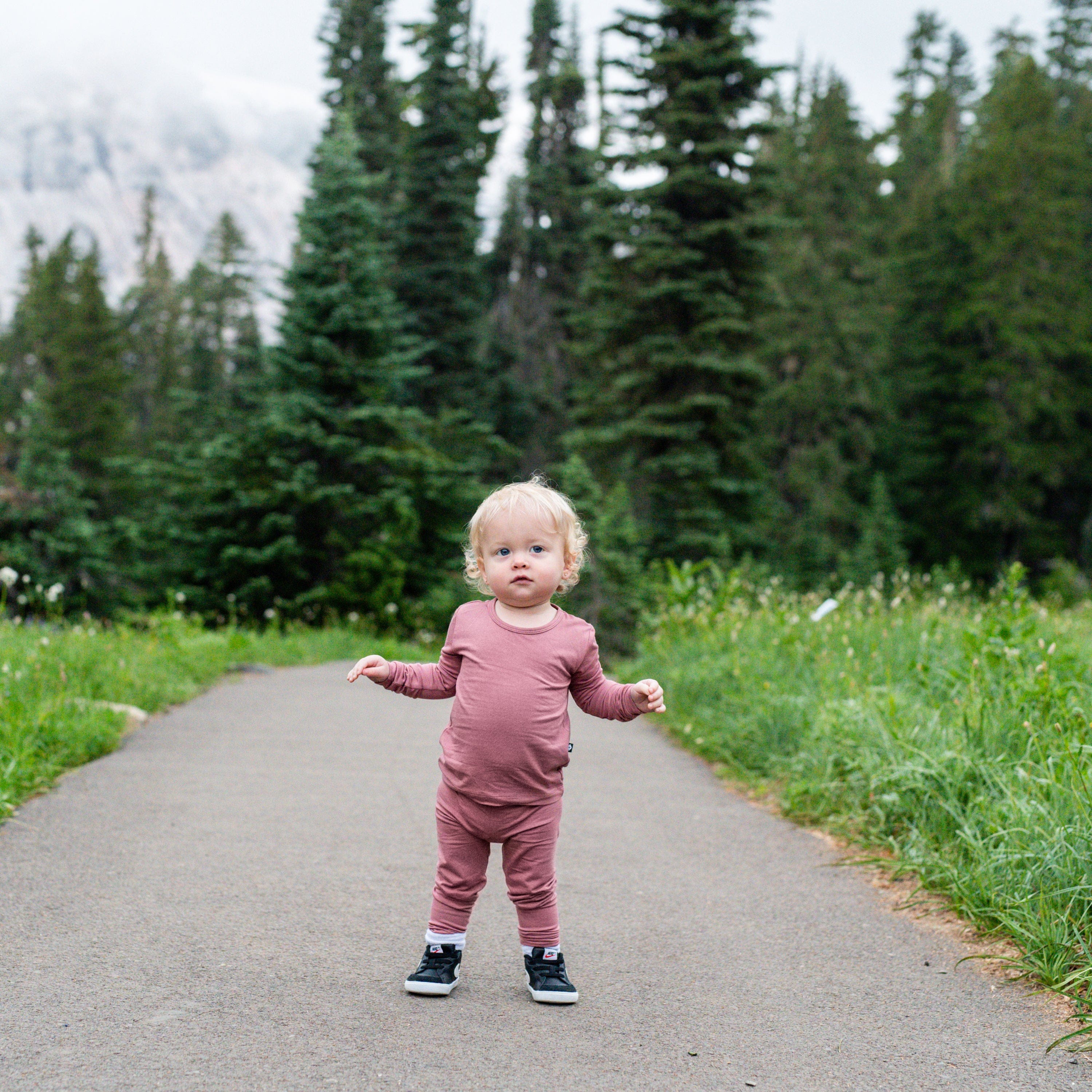 Toddler wearing Kyte Baby bamboo Long Sleeve Pajamas in Dusty Rose
