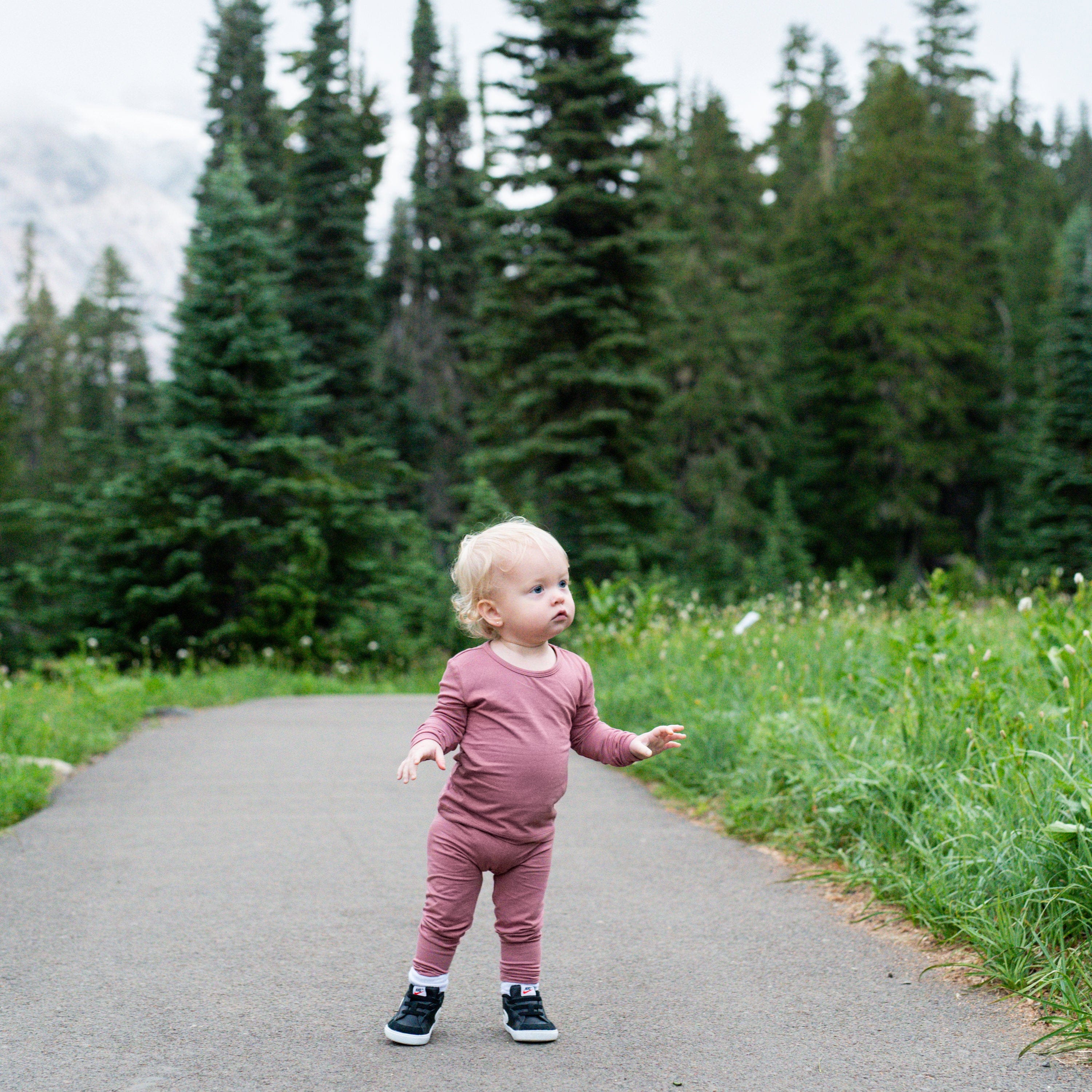 Child wearing Kyte Baby Long Sleeve Pjs in Dusty Rose