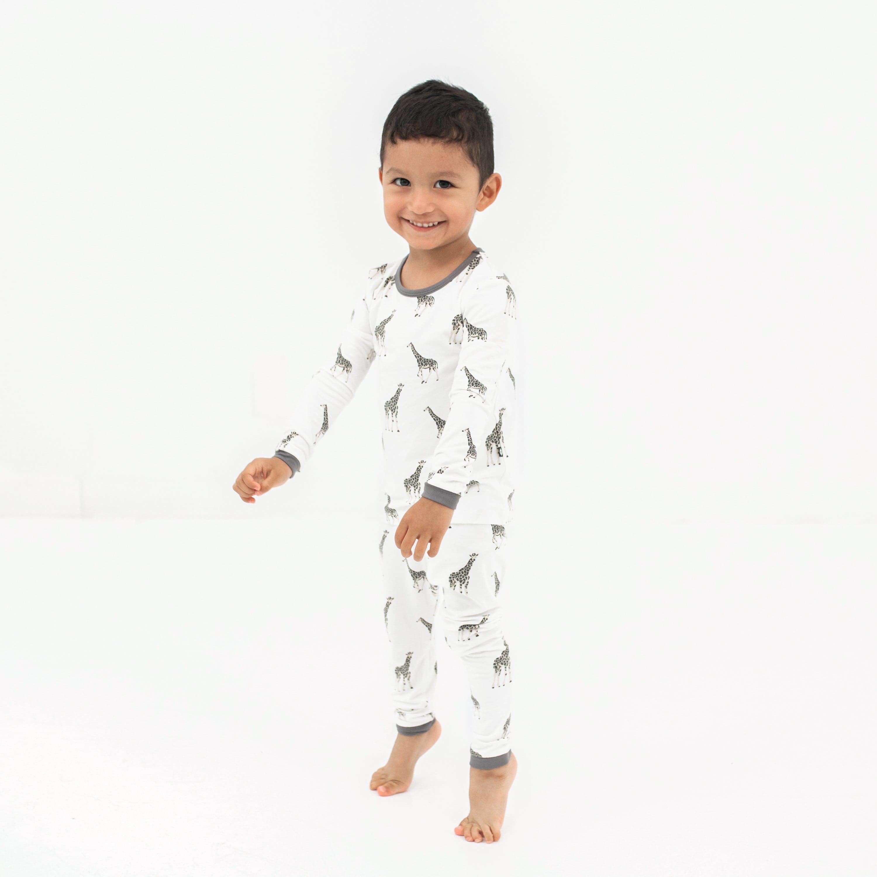 Child wearing Kyte Baby Long Sleeve Pajama Set in Giraffe
