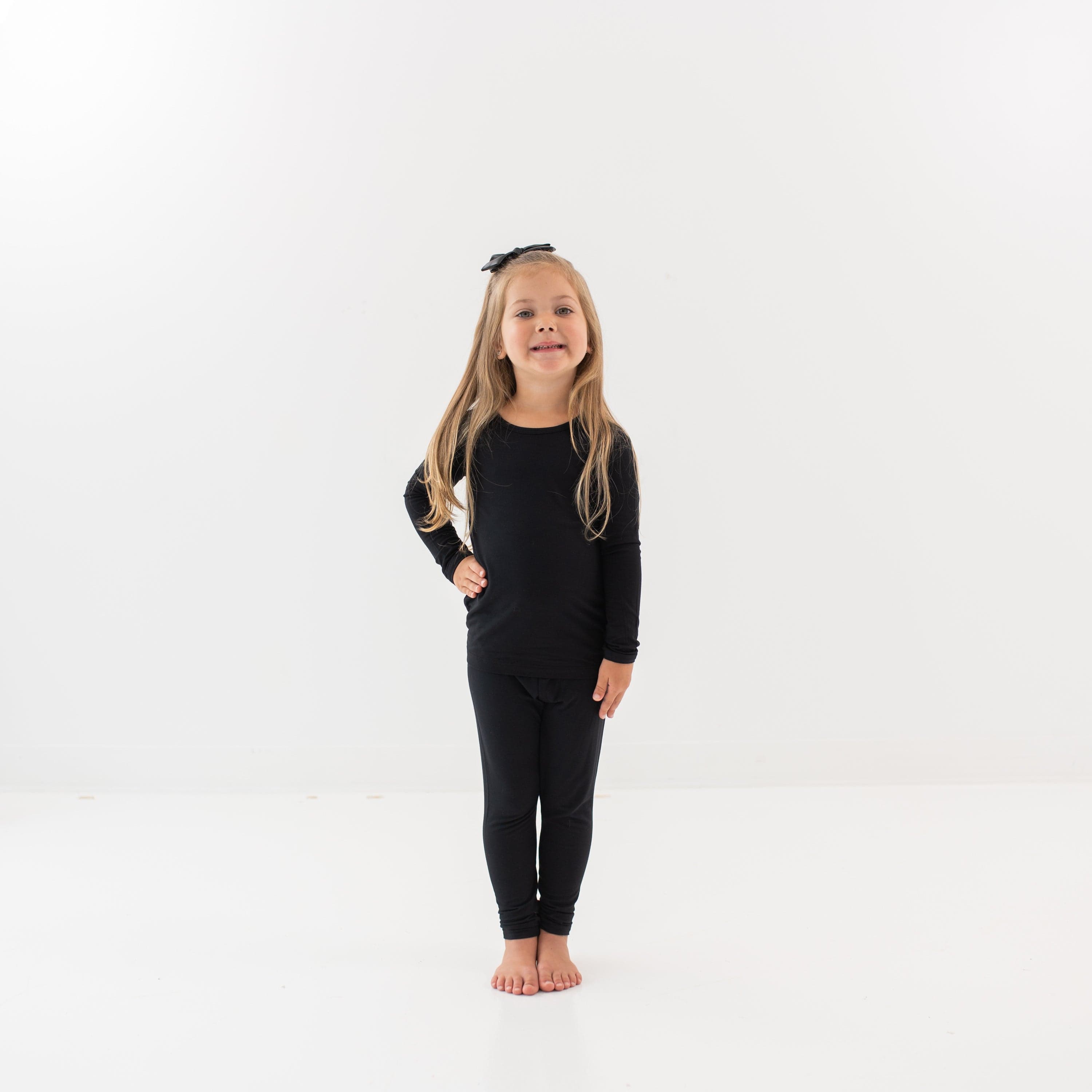 Smiling little girl wearing Long Sleeve Pajama Set in Midnight