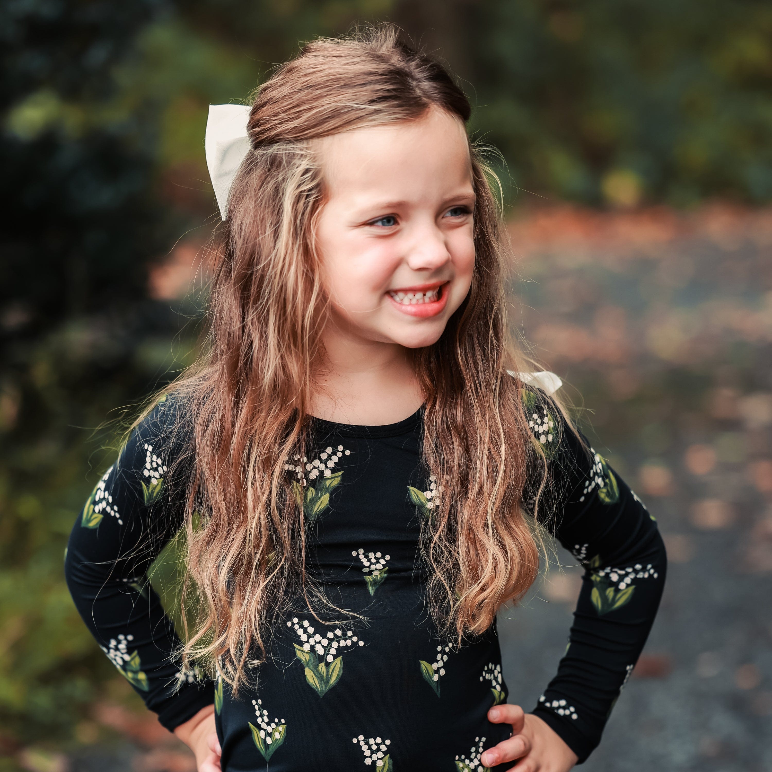 Girl wearing two piece Kyte Baby Long Sleeve Pajamas in Midnight Lily