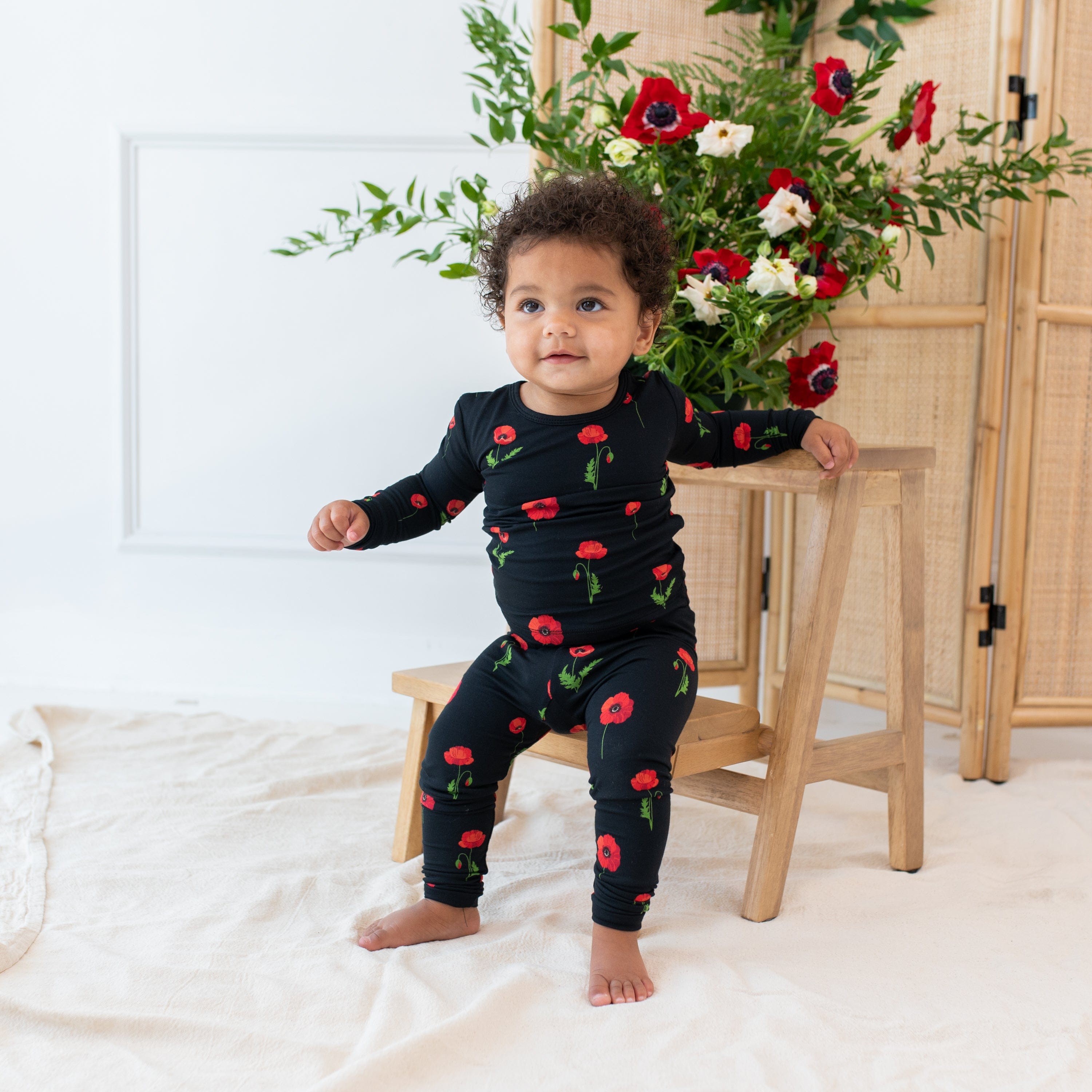 Toddler wearing Kyte Baby bamboo Long Sleeve Pajamas in Midnight Poppies