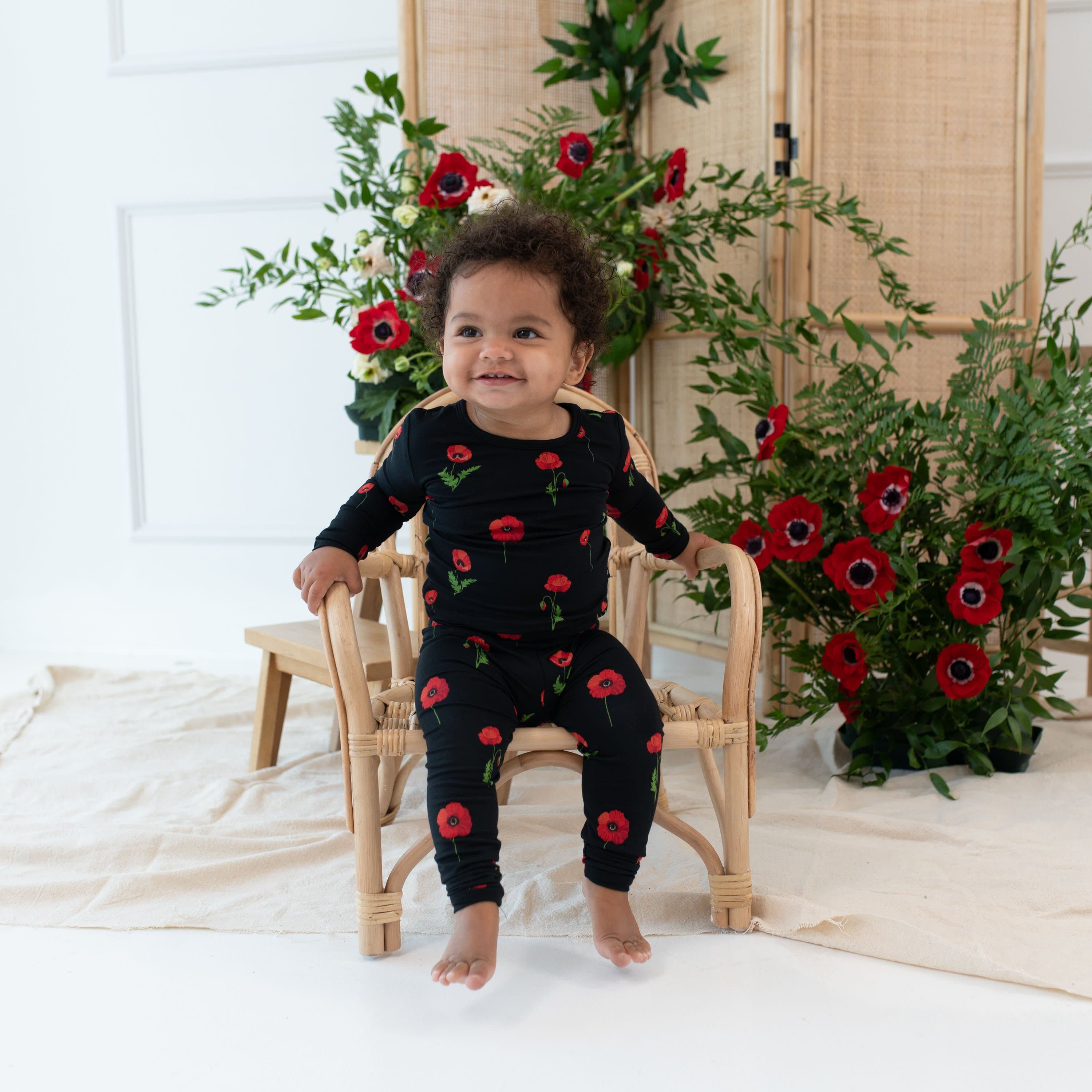 Toddler wearing Kyte Baby Long Sleeve Pajamas in Midnight Poppies