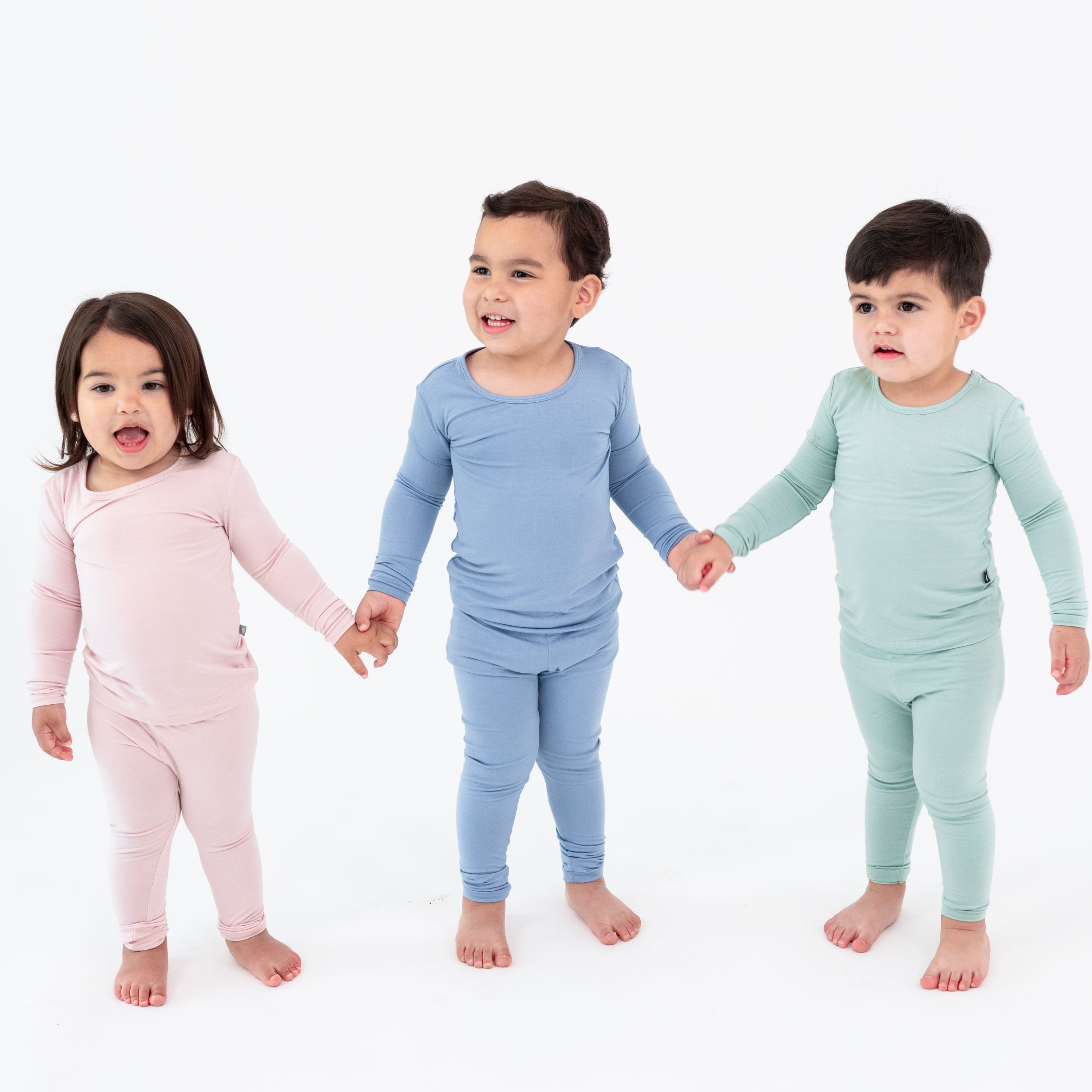 Kids wearing Kyte Baby long sleeve bamboo pajamas