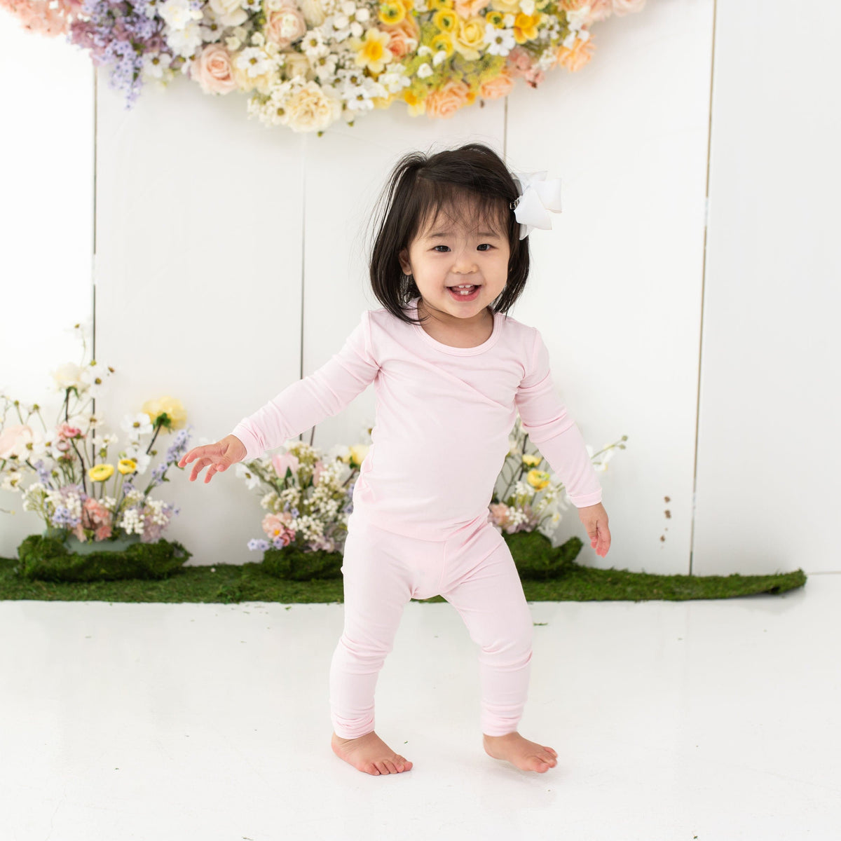 Child wearing Kyte Baby Long Sleeve Pajamas in Sakura