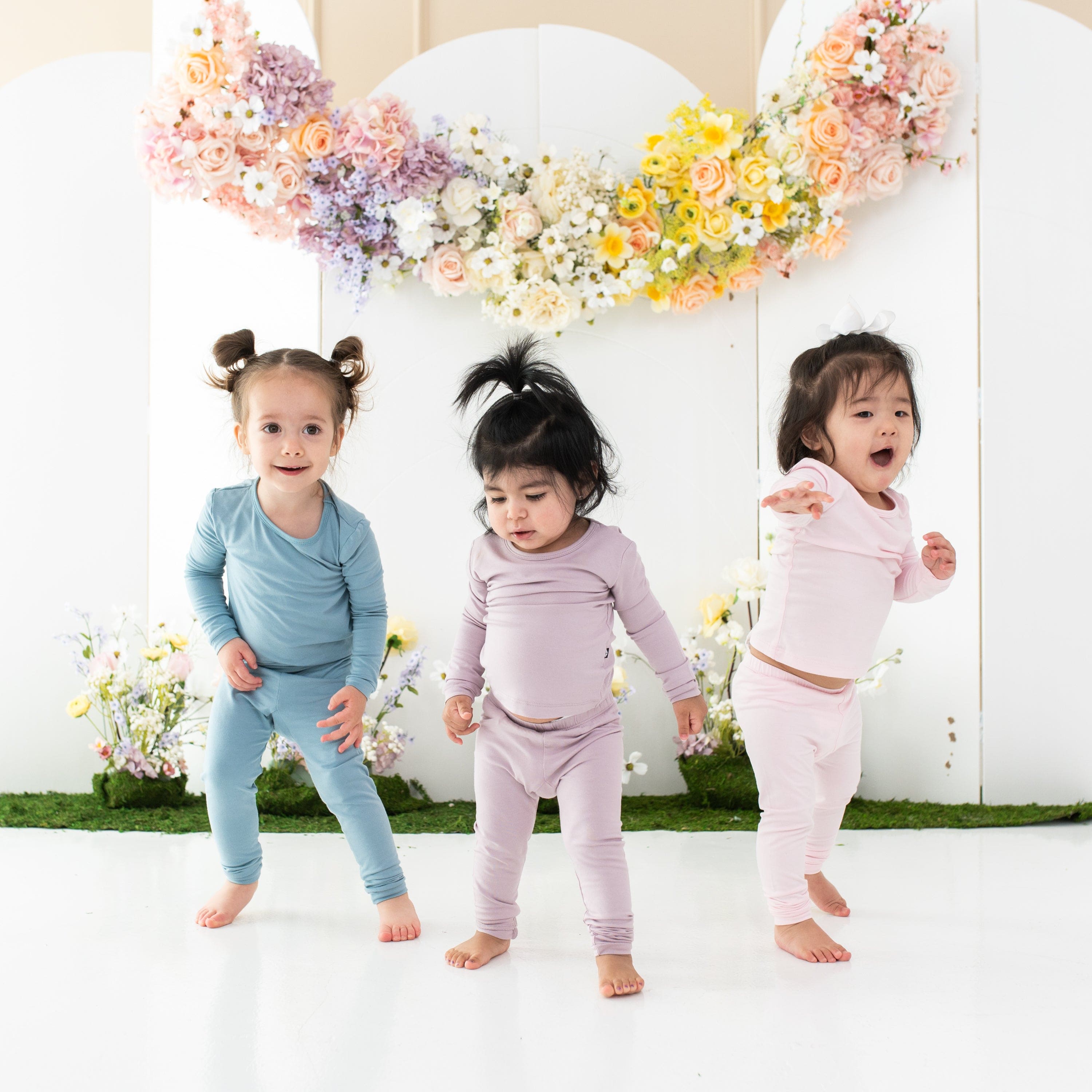 Children wearing Kyte Baby long sleeve kids pajamas