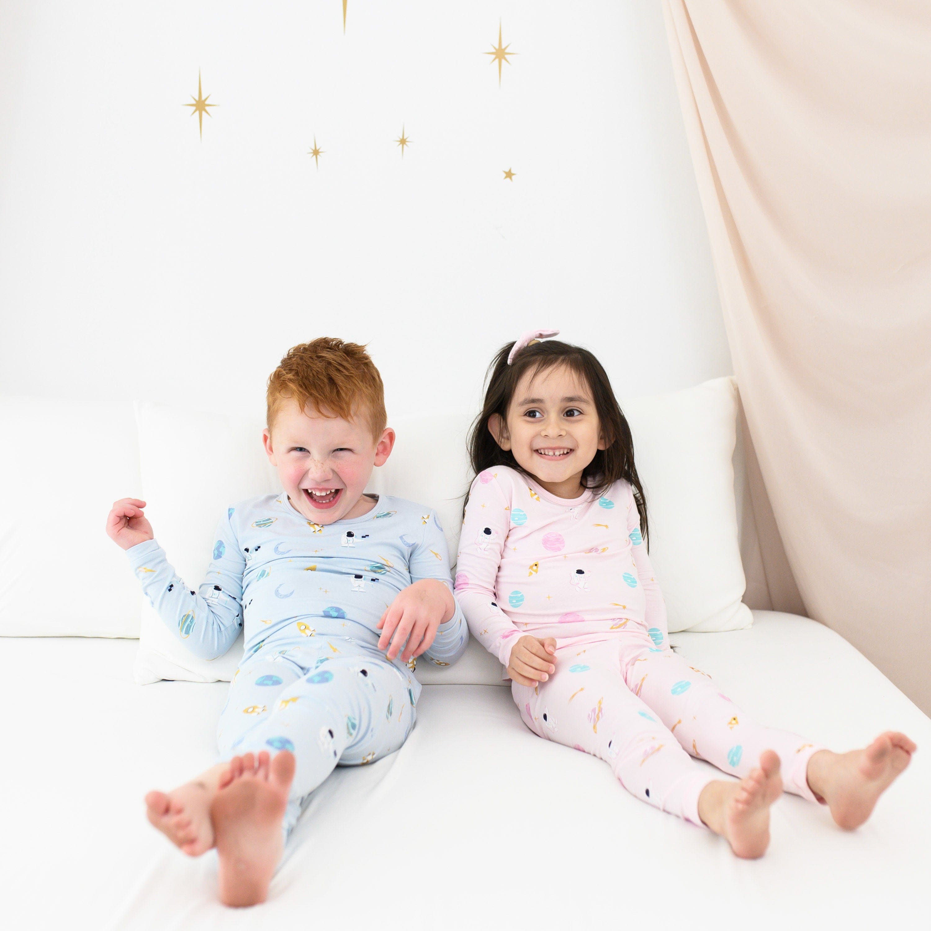 Kids wearing Long Sleeve Space Pajamas in blue and pink
