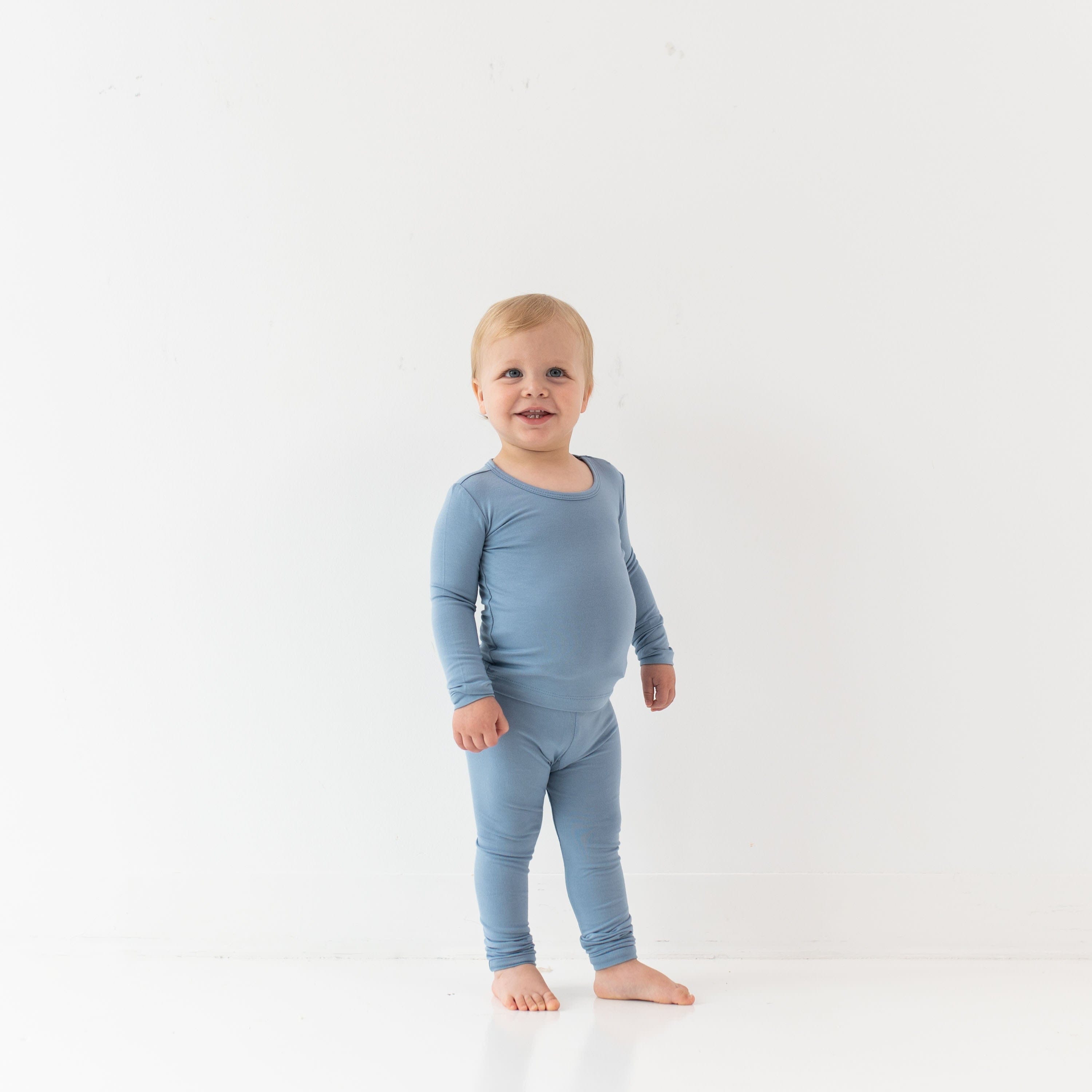 Toddler wearing Kyte Baby Long Sleeve Pajamas in Slate