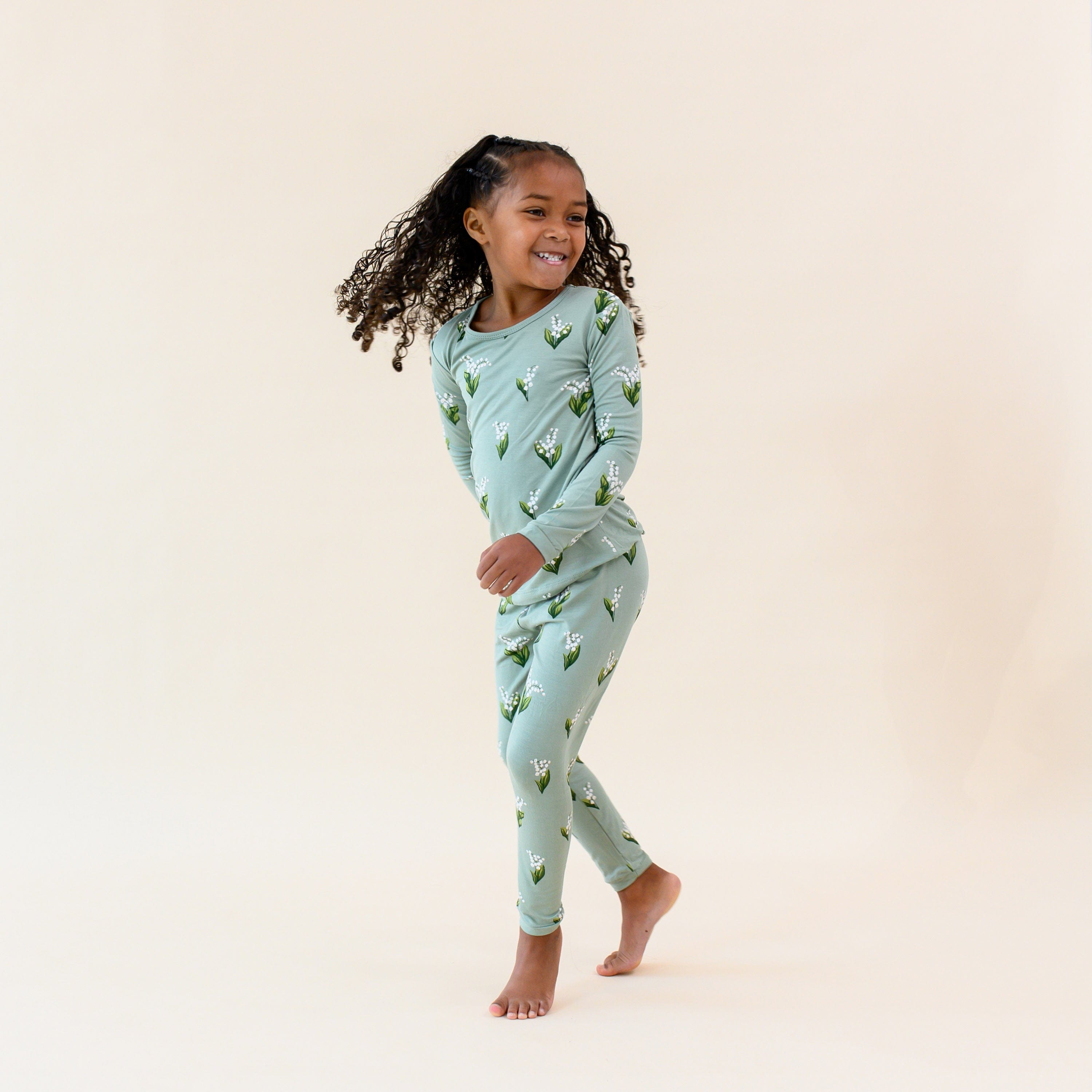 Girl in Long Sleeve Toddler Pajamas in Green Thyme Lily