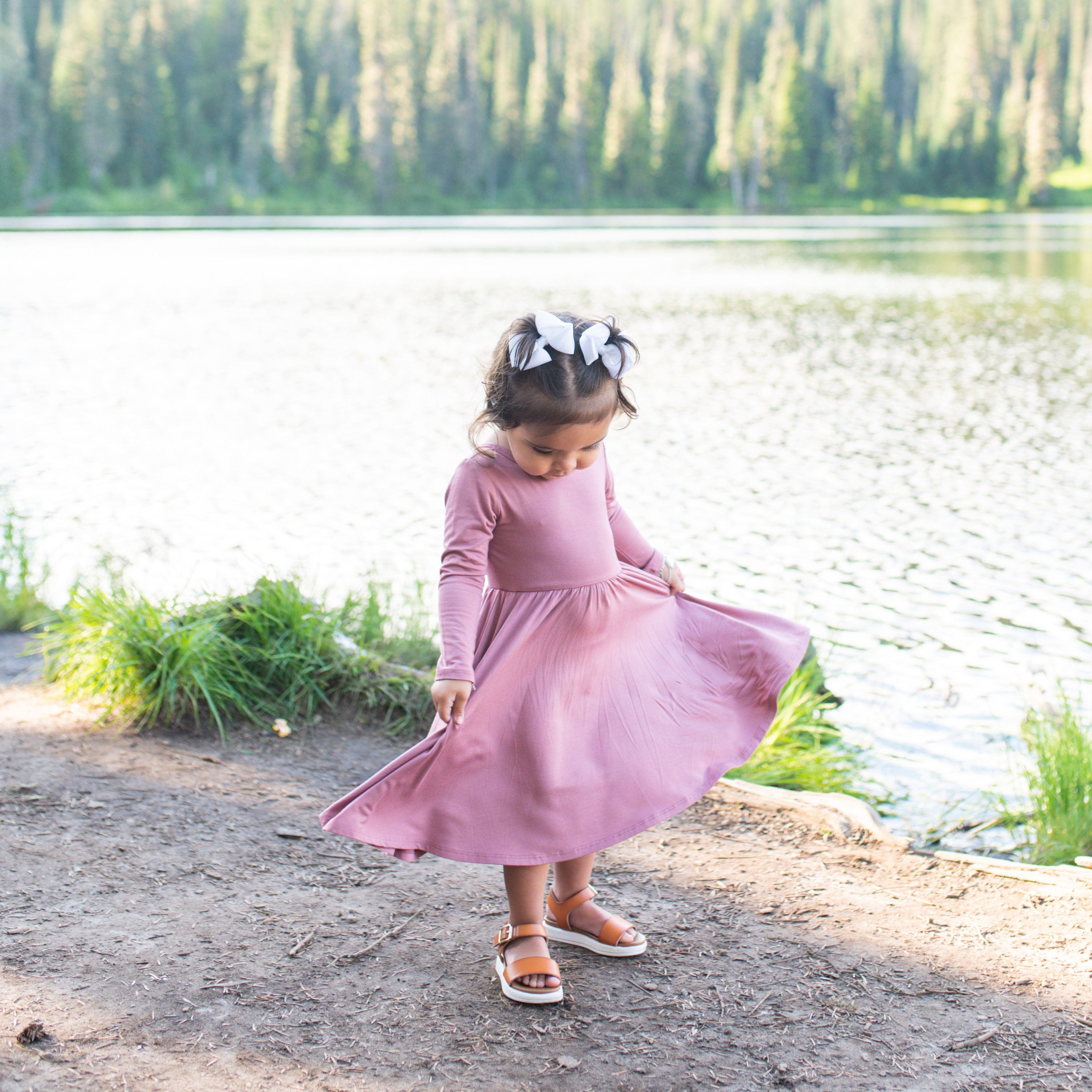 Girl wearing Kyte Baby Long Sleeve Twirl Dress in Dusty Rose
