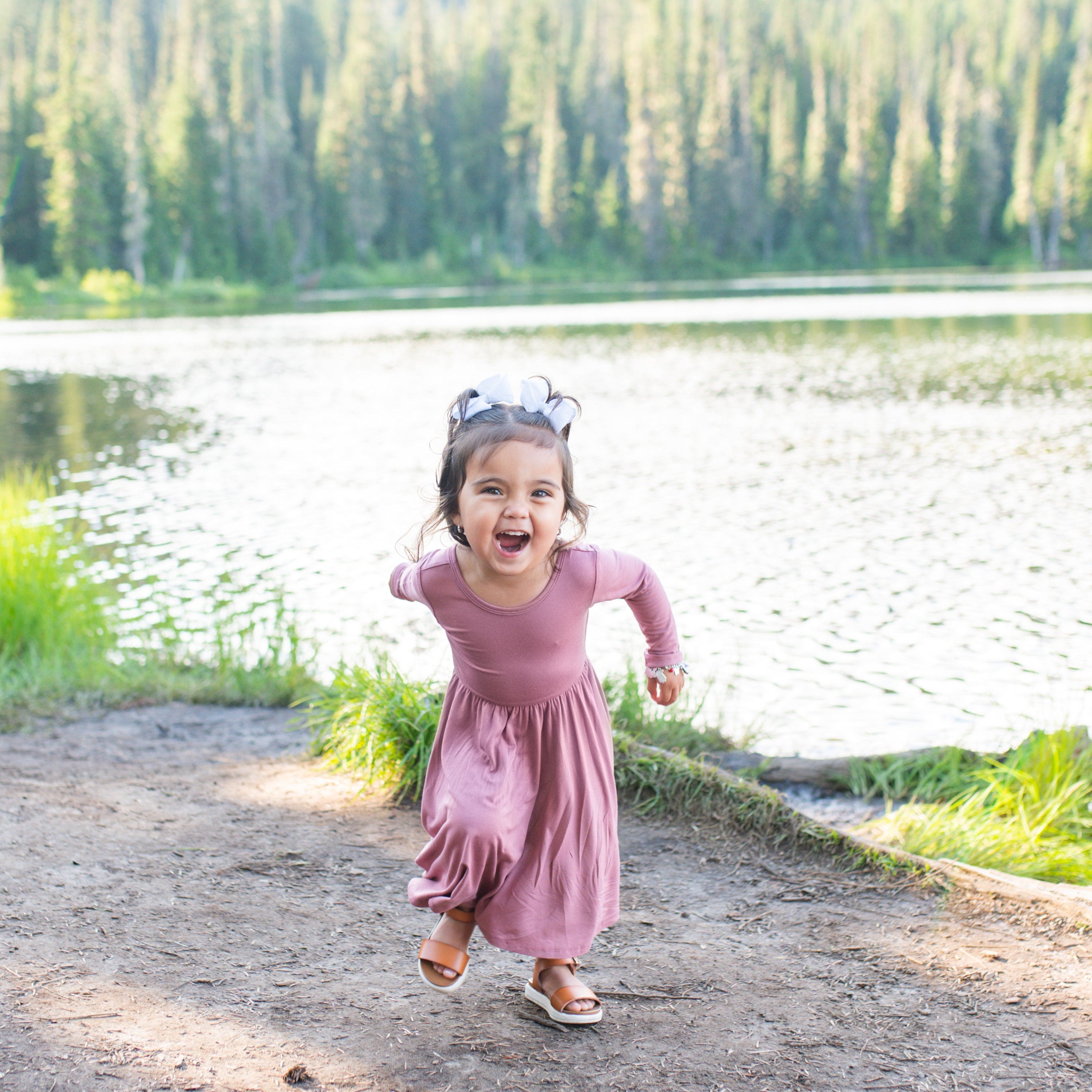 Toddler wearing Kyte Baby bamboo Long Sleeve Twirl Dress in Dusty Rose