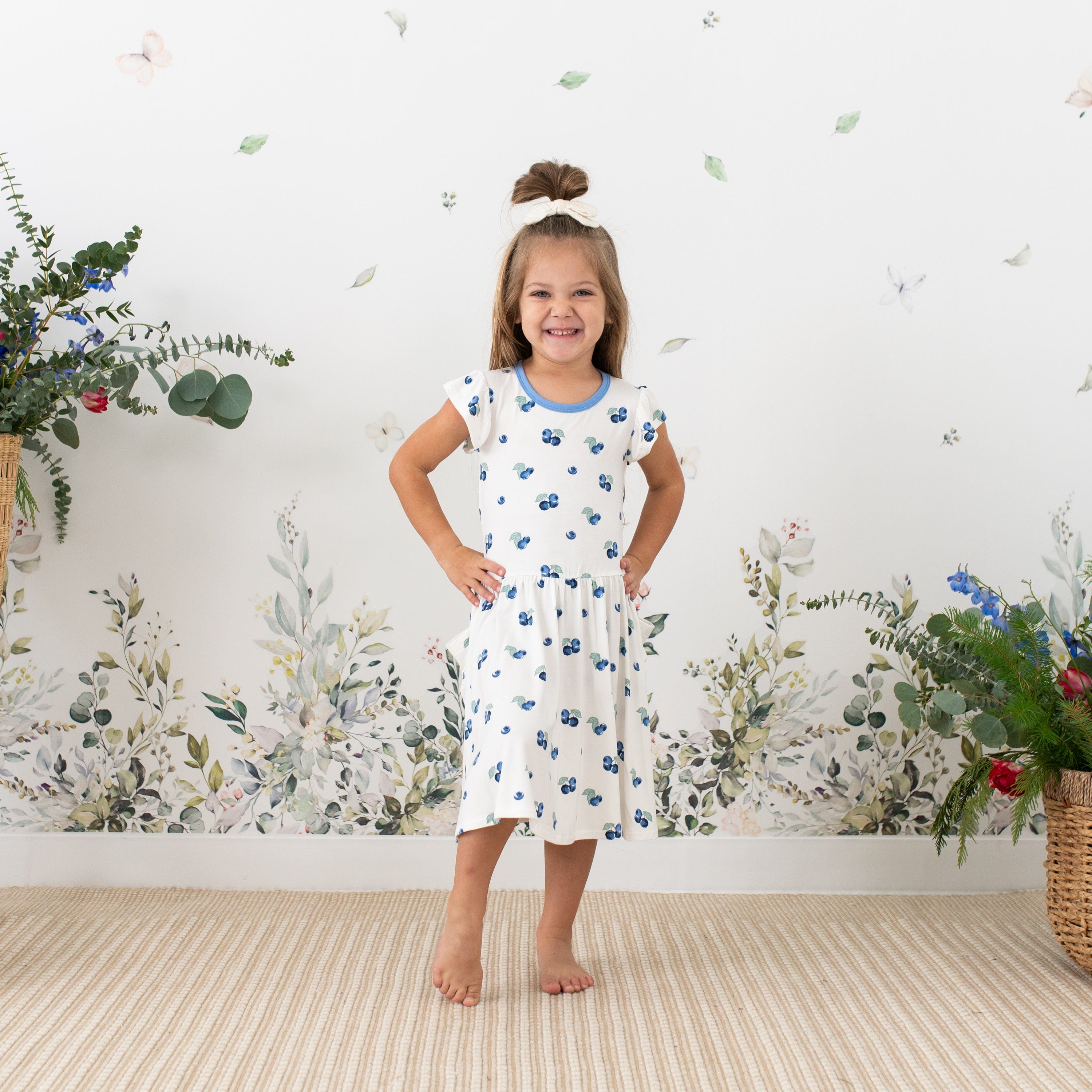 Girl wearing Kyte Baby Pocket Dress in Blueberry