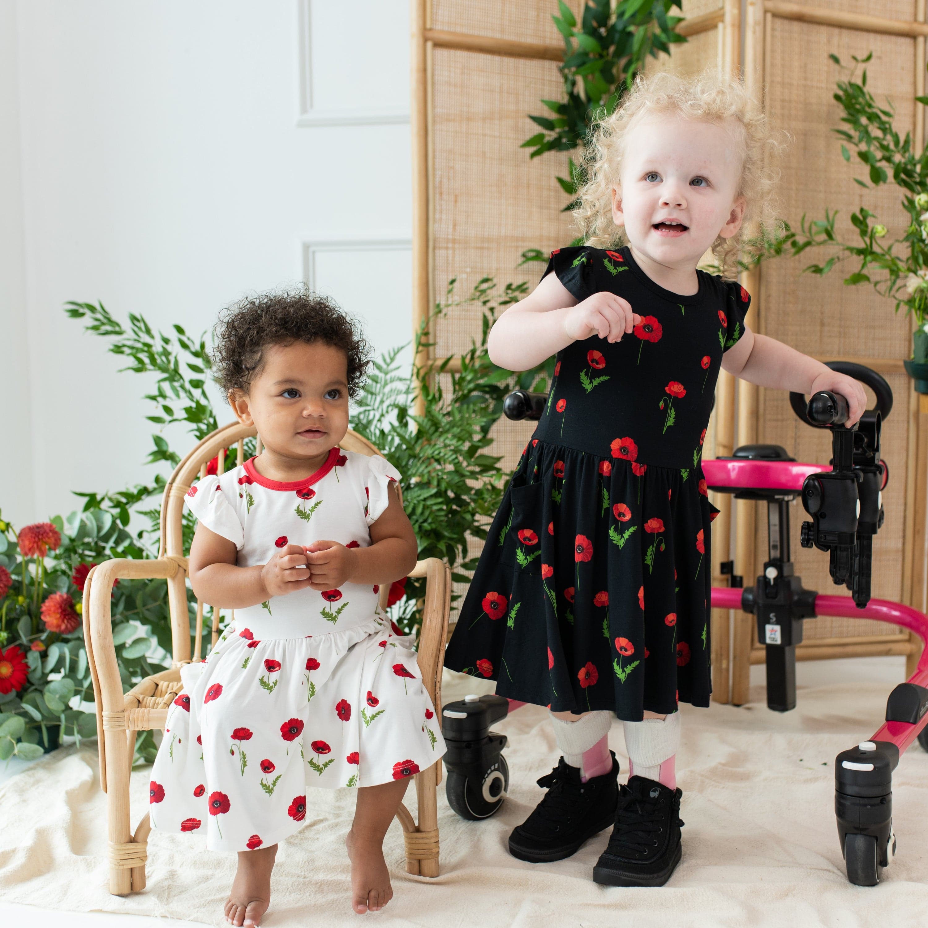 Toddlers wearing matching Kyte Baby Pocket Dress in Poppies