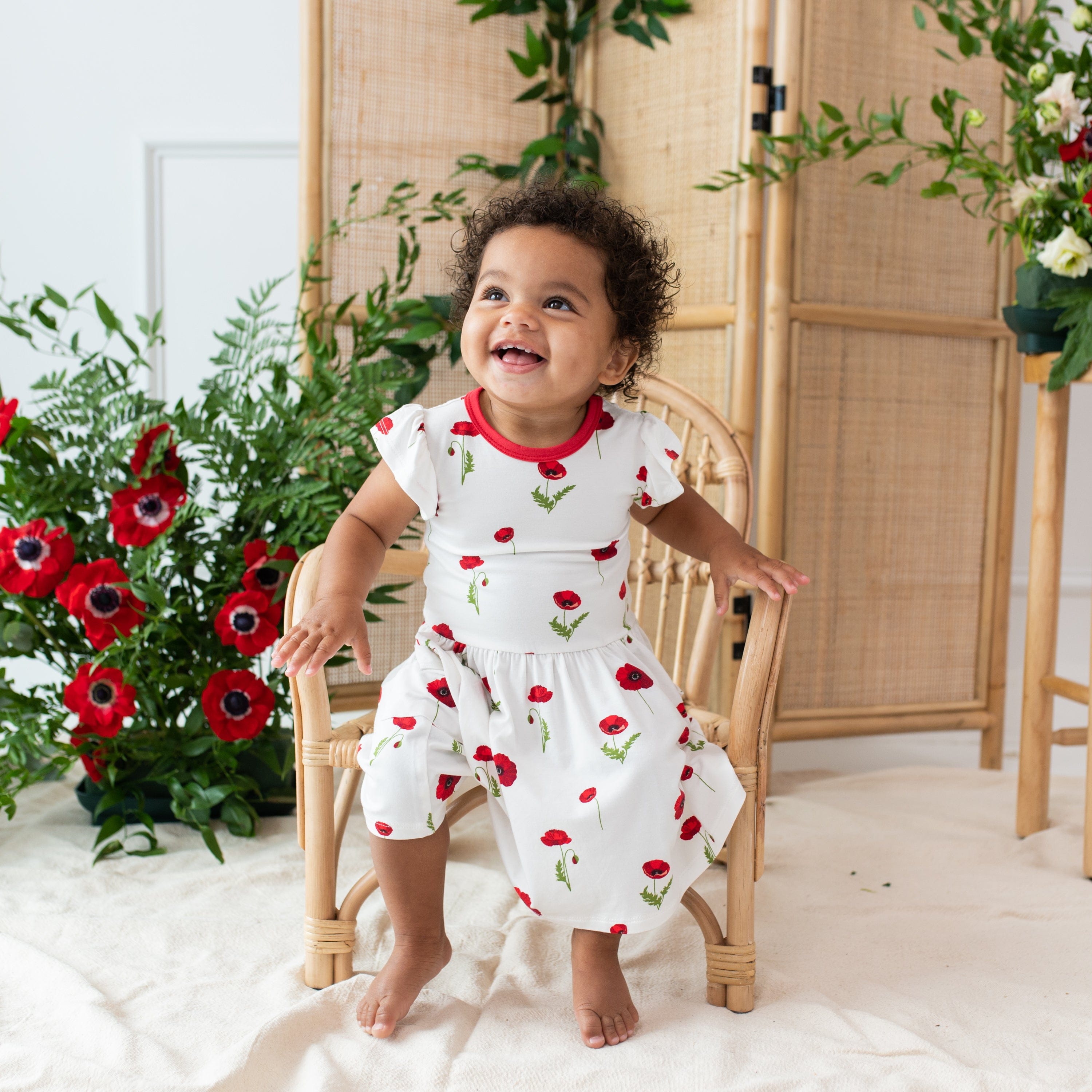 Toddler wearing Kyte Baby Pocket Dress in Cloud Poppies