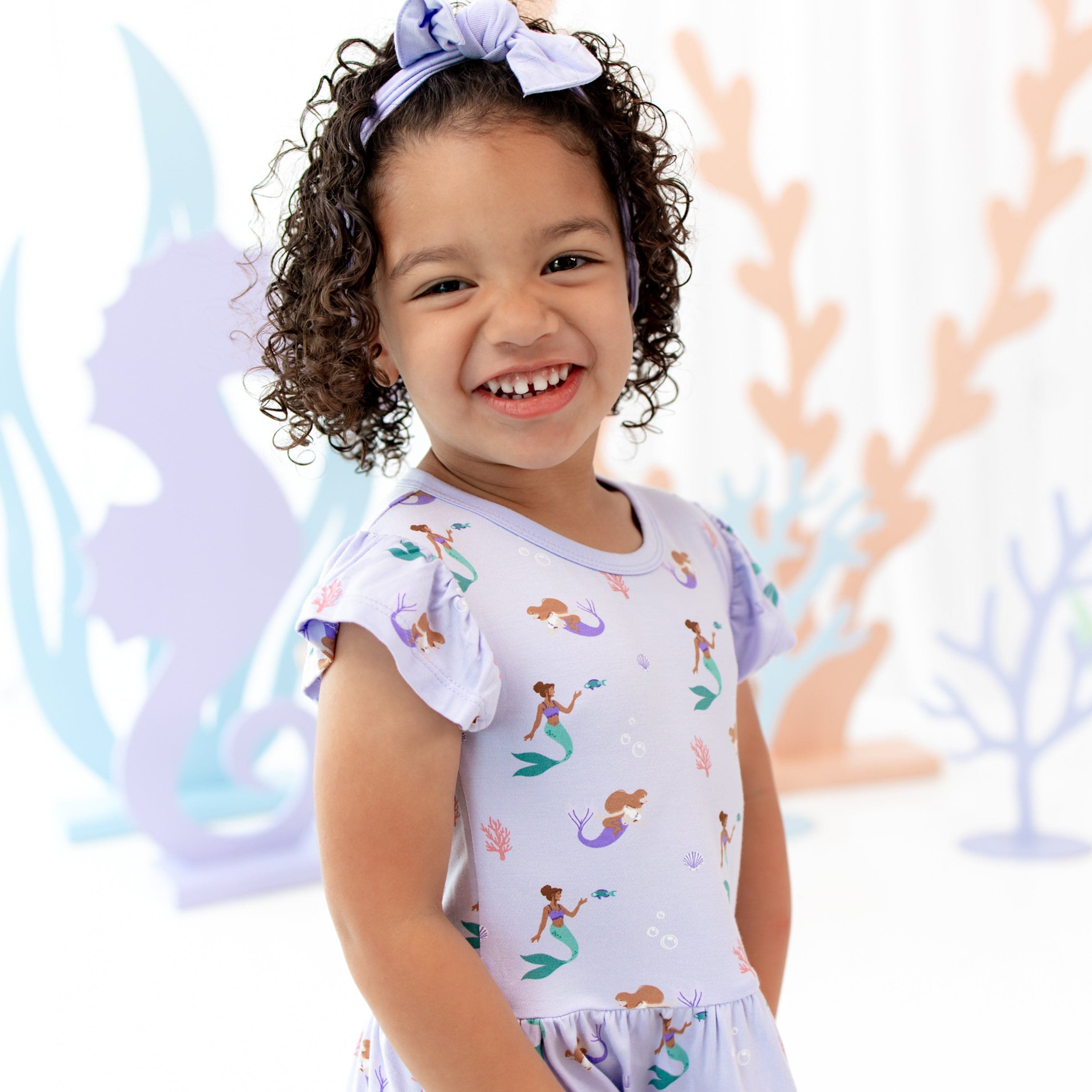 Toddler wearing Kyte Baby Pocket Dress in Mermaid