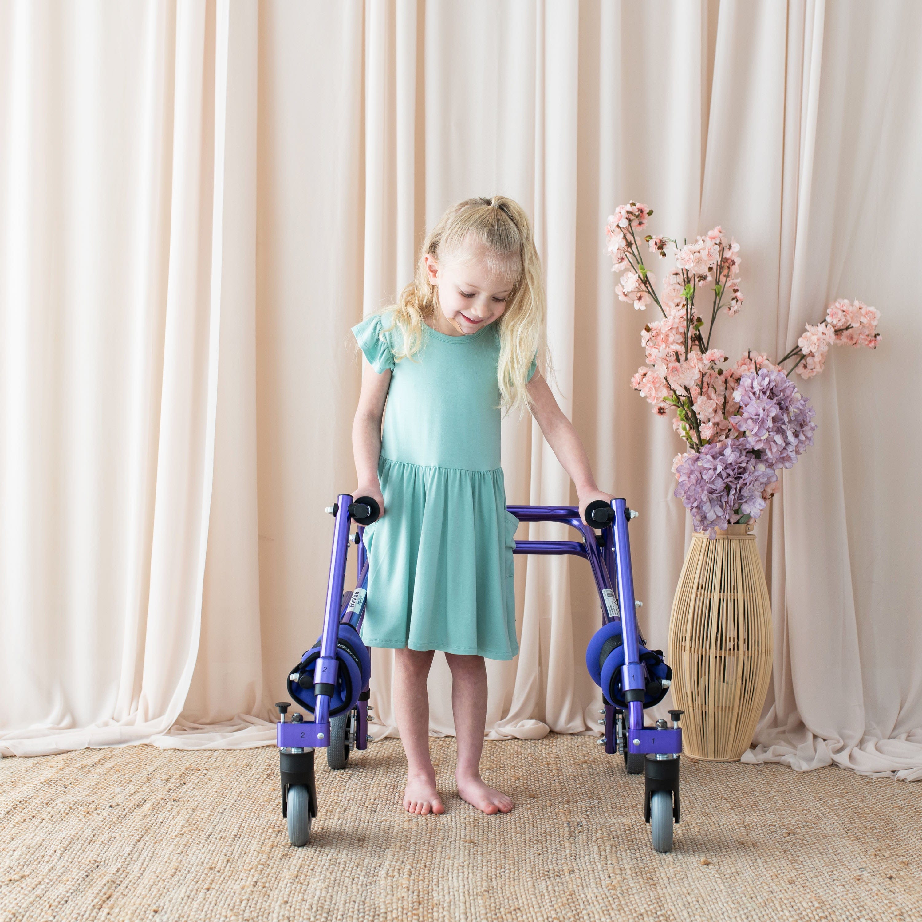Child wearing Kyte Baby bamboo Pocket Dress in Wasabi green