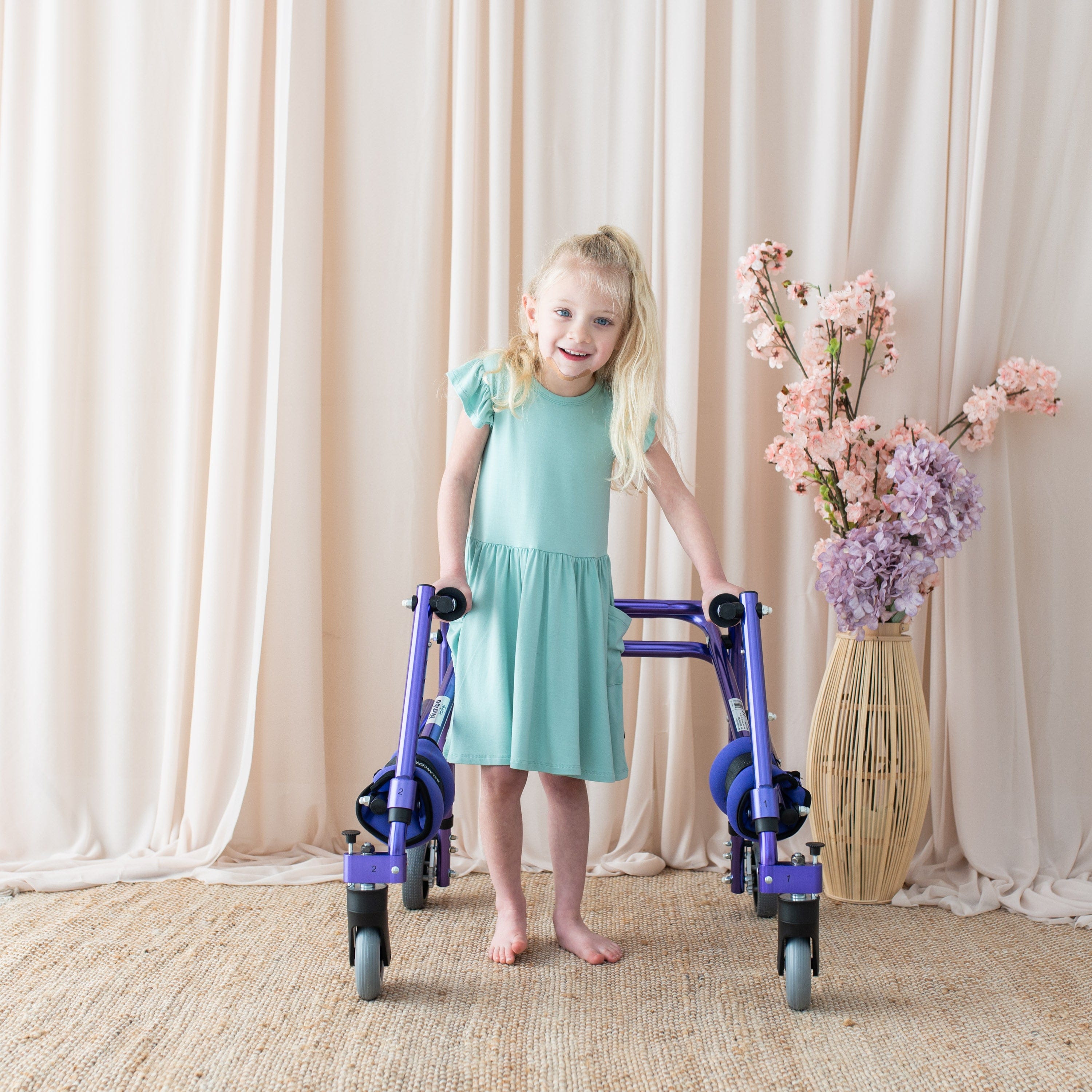 Girl wearing Kyte Baby Pocket Dress in Wasabi