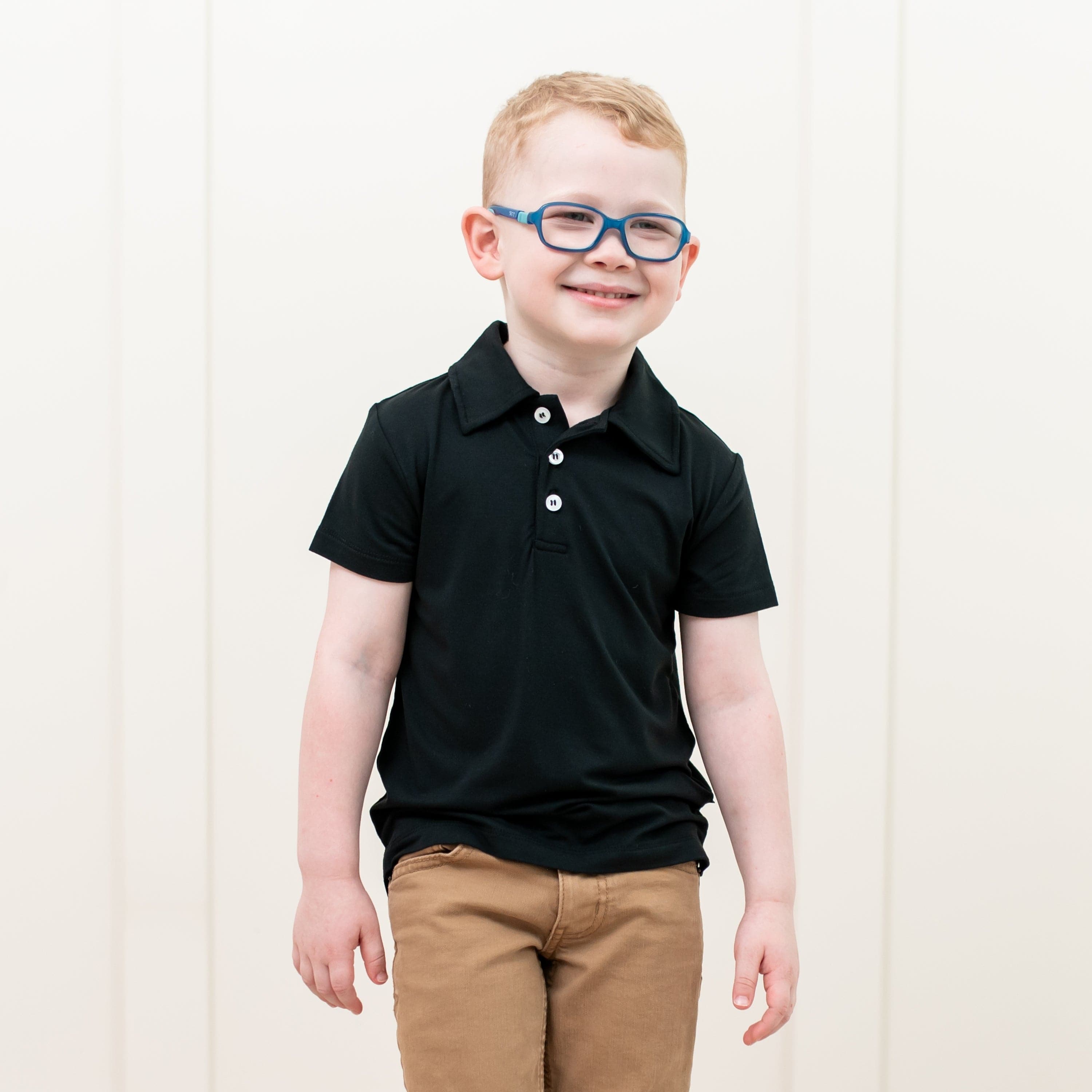 Toddler wearing Kyte Baby Short Sleeve Shirt with Polo Collar in Midnight black
