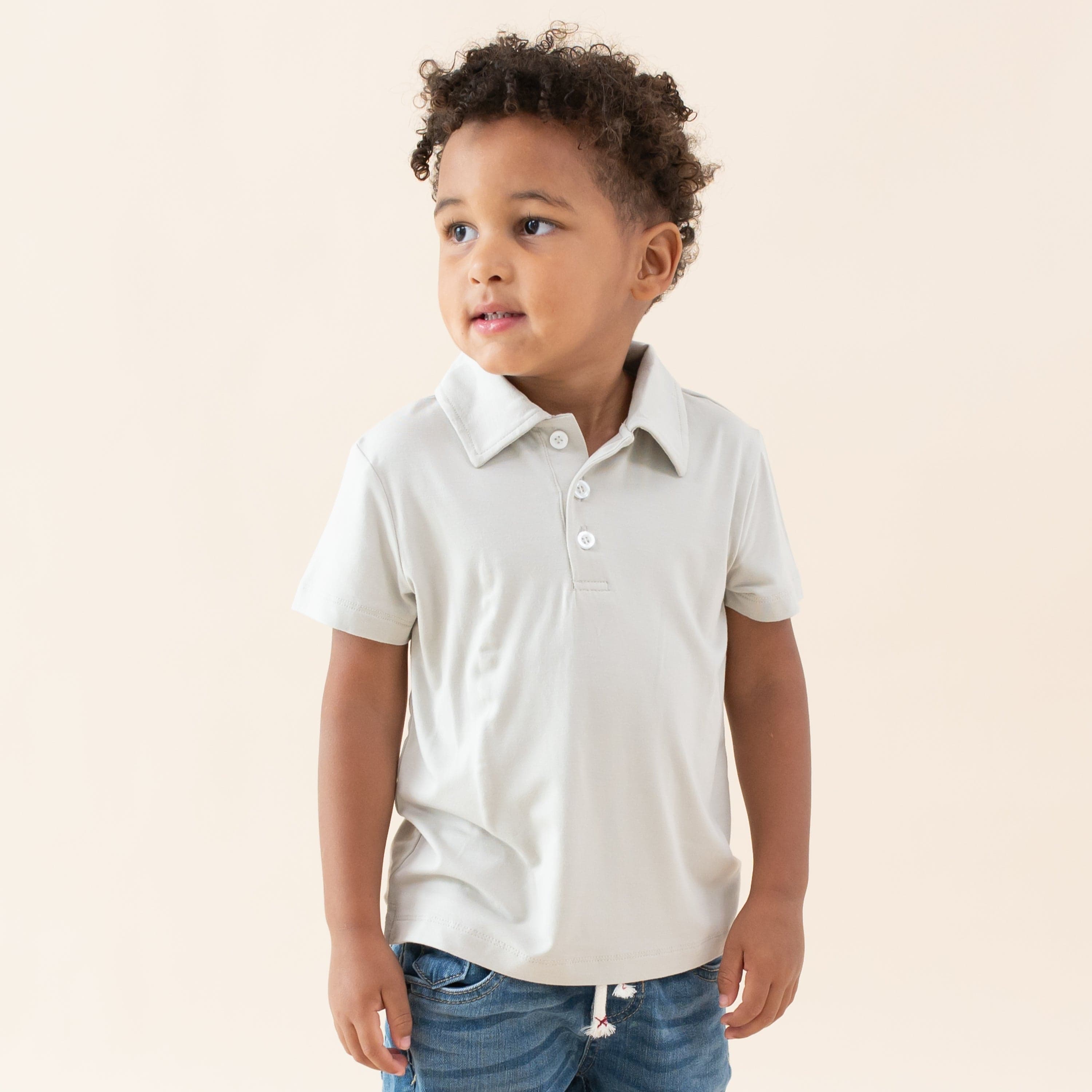Toddler wearing Kyte Baby Short Sleeve Polo in Oat