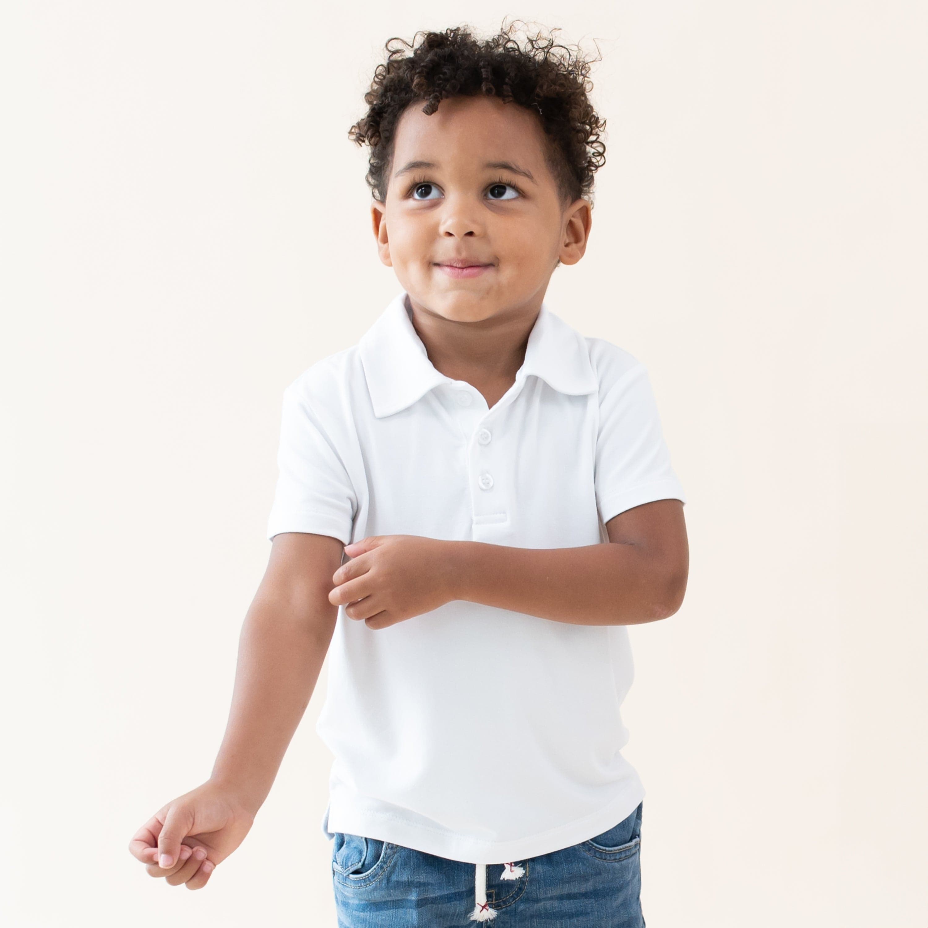 Toddler wearing Kyte Baby Short Sleeve Shirt with Polo Collar in Snow White