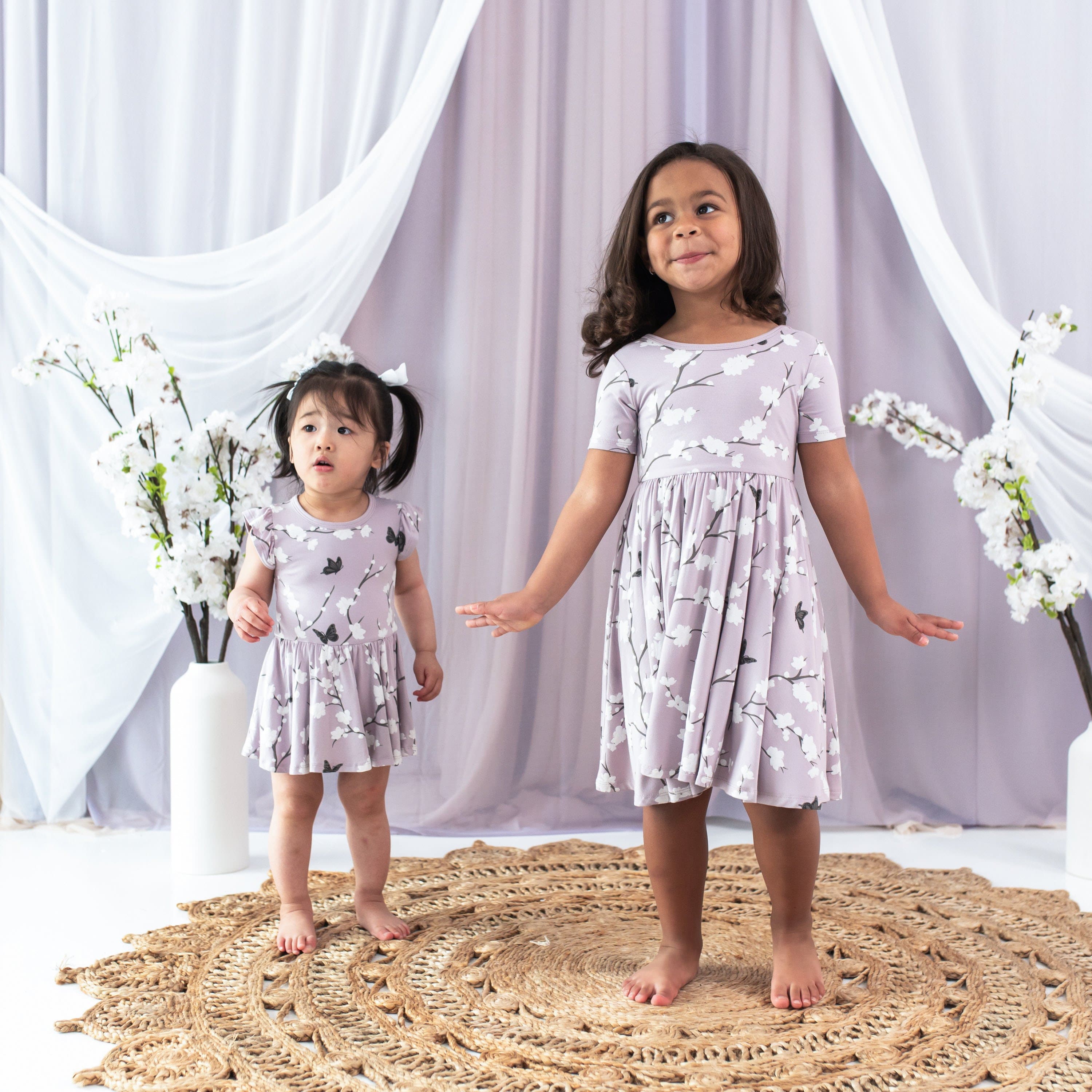 Girls wearing Kyte Baby Twirl Dress in Cherry Blossom