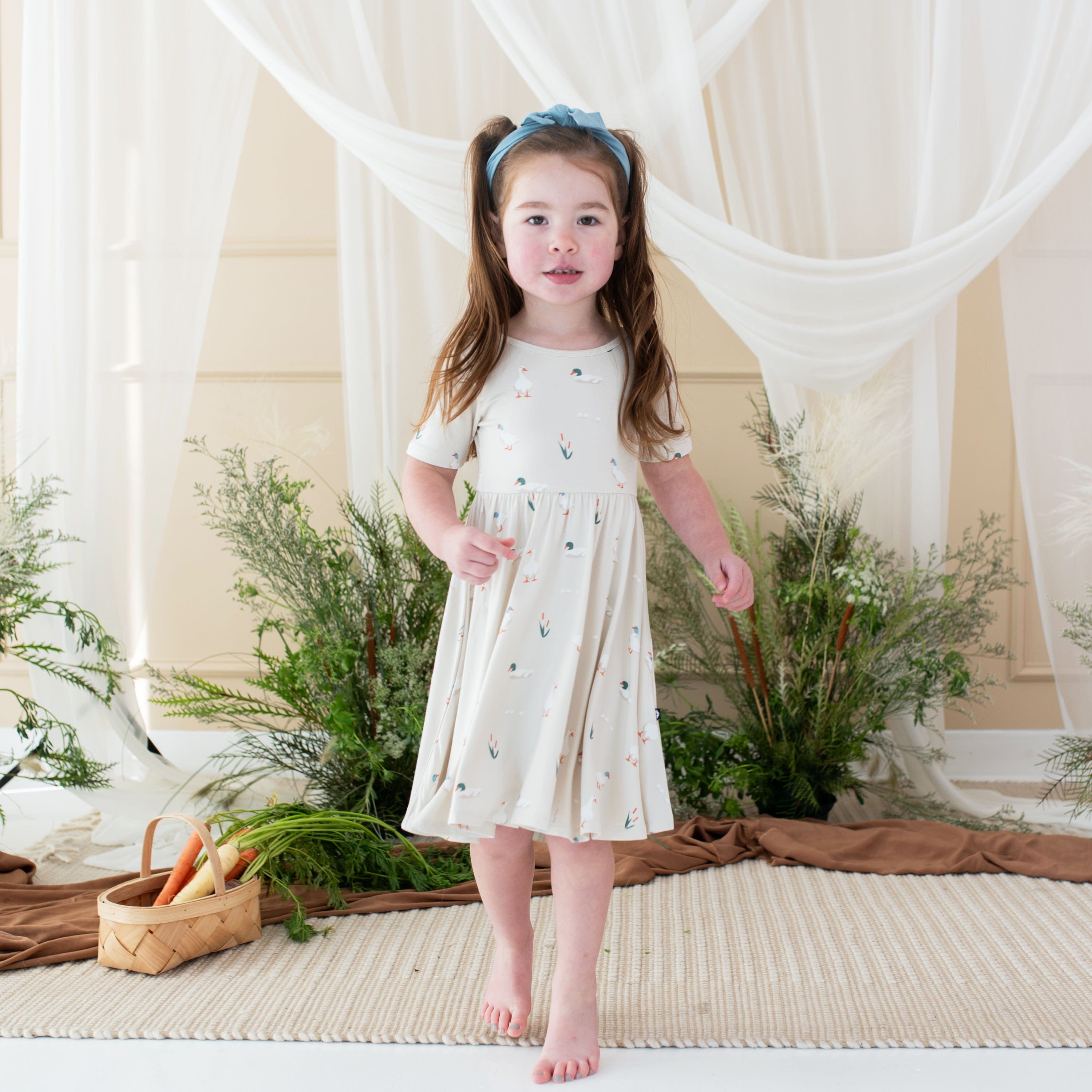 Toddler wearing Kyte Baby Twirl Dress in Duck