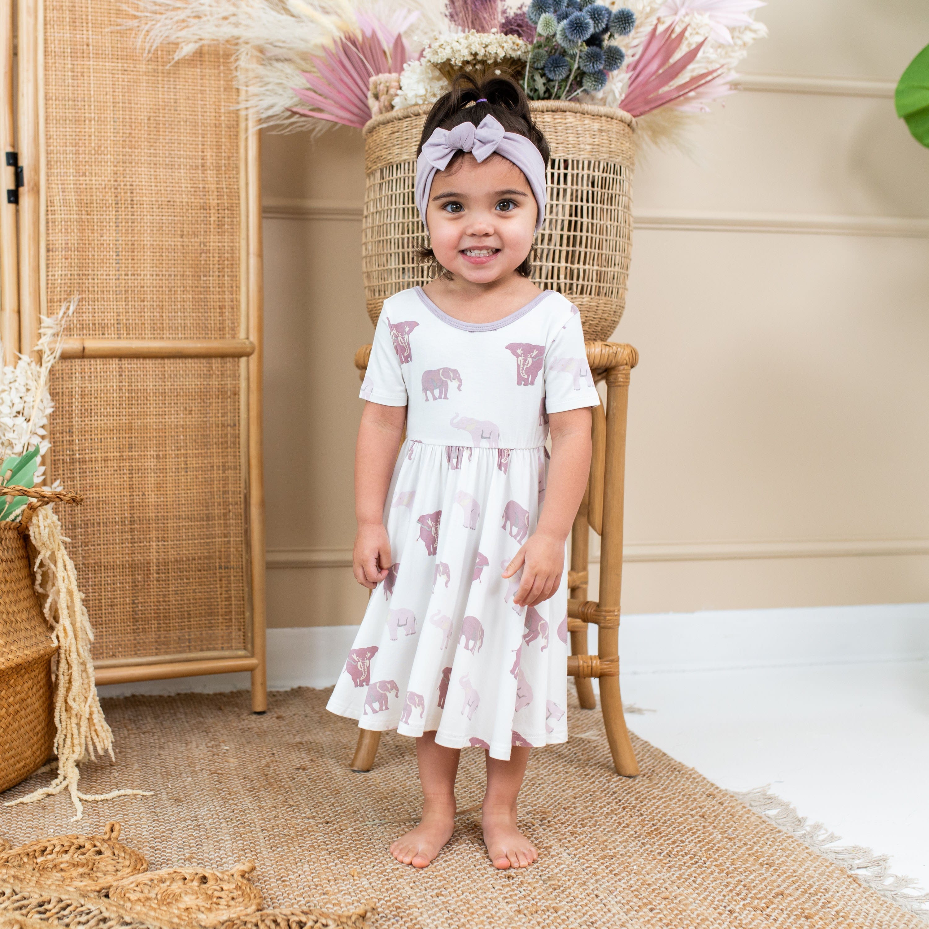 Girl wearing Kyte Baby Twirl Dress in Elephant