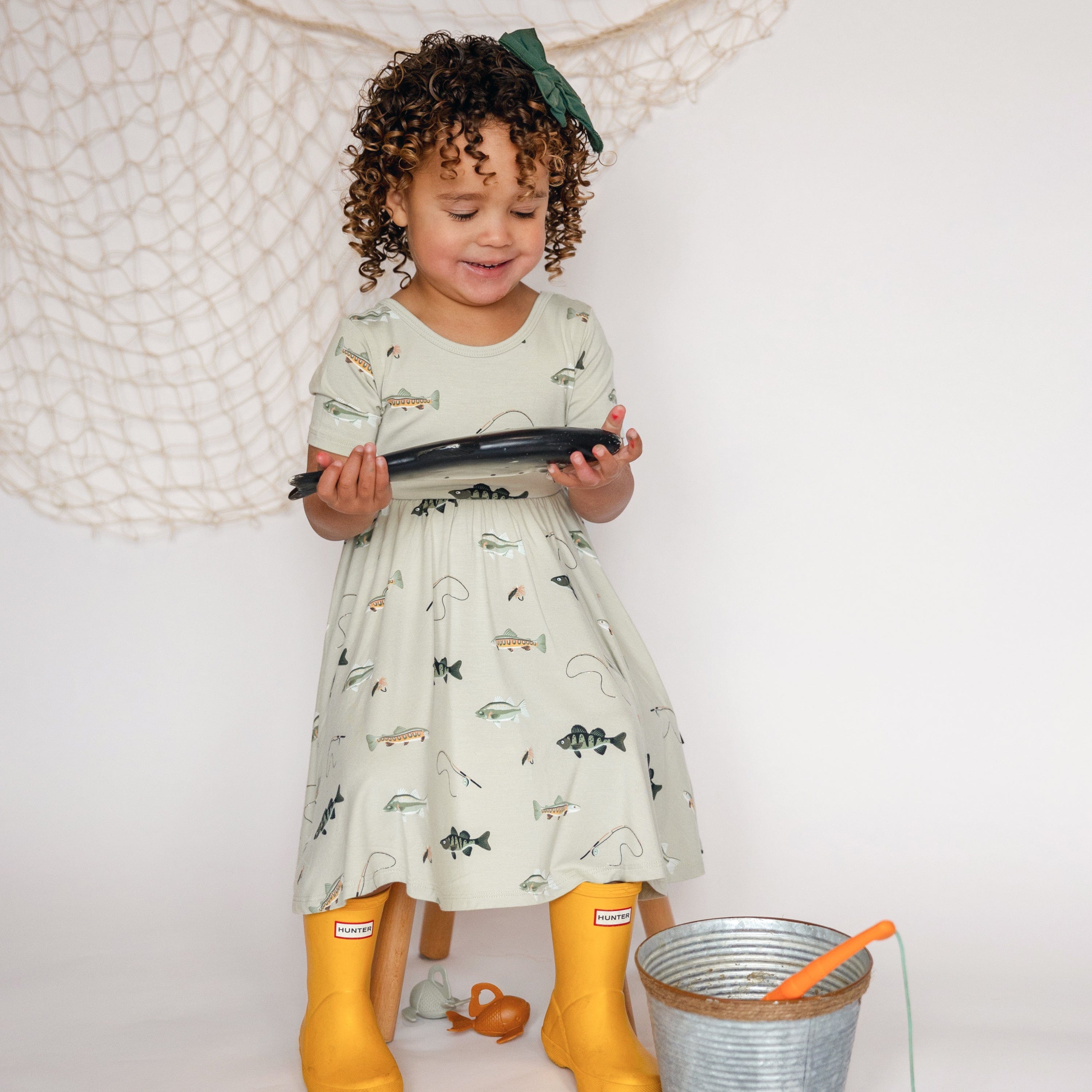 Toddler wearing Kyte Baby Short Sleeve Twirl Dress in Fishing