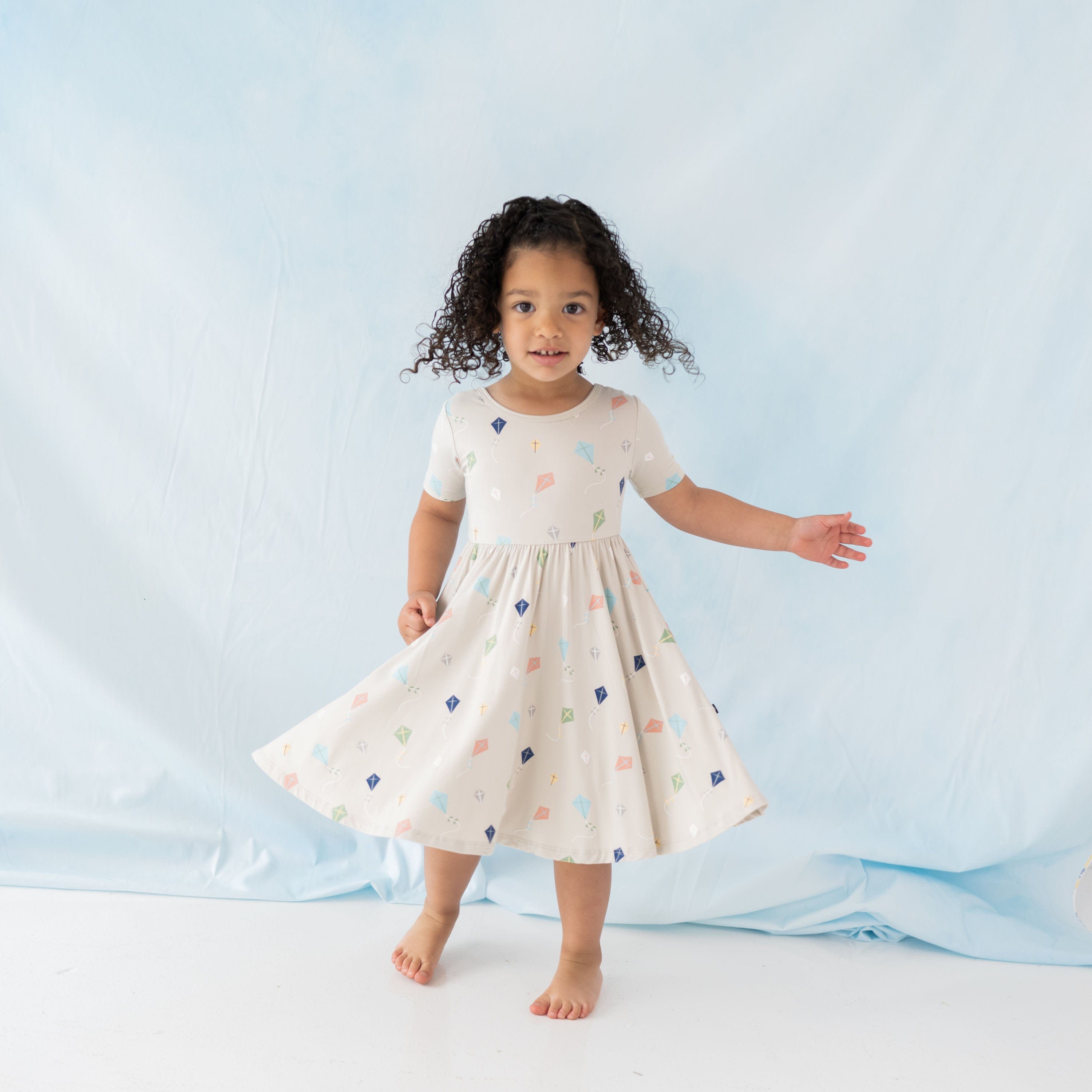 Girl wearing Kyte Baby Twirl Dress in Kite