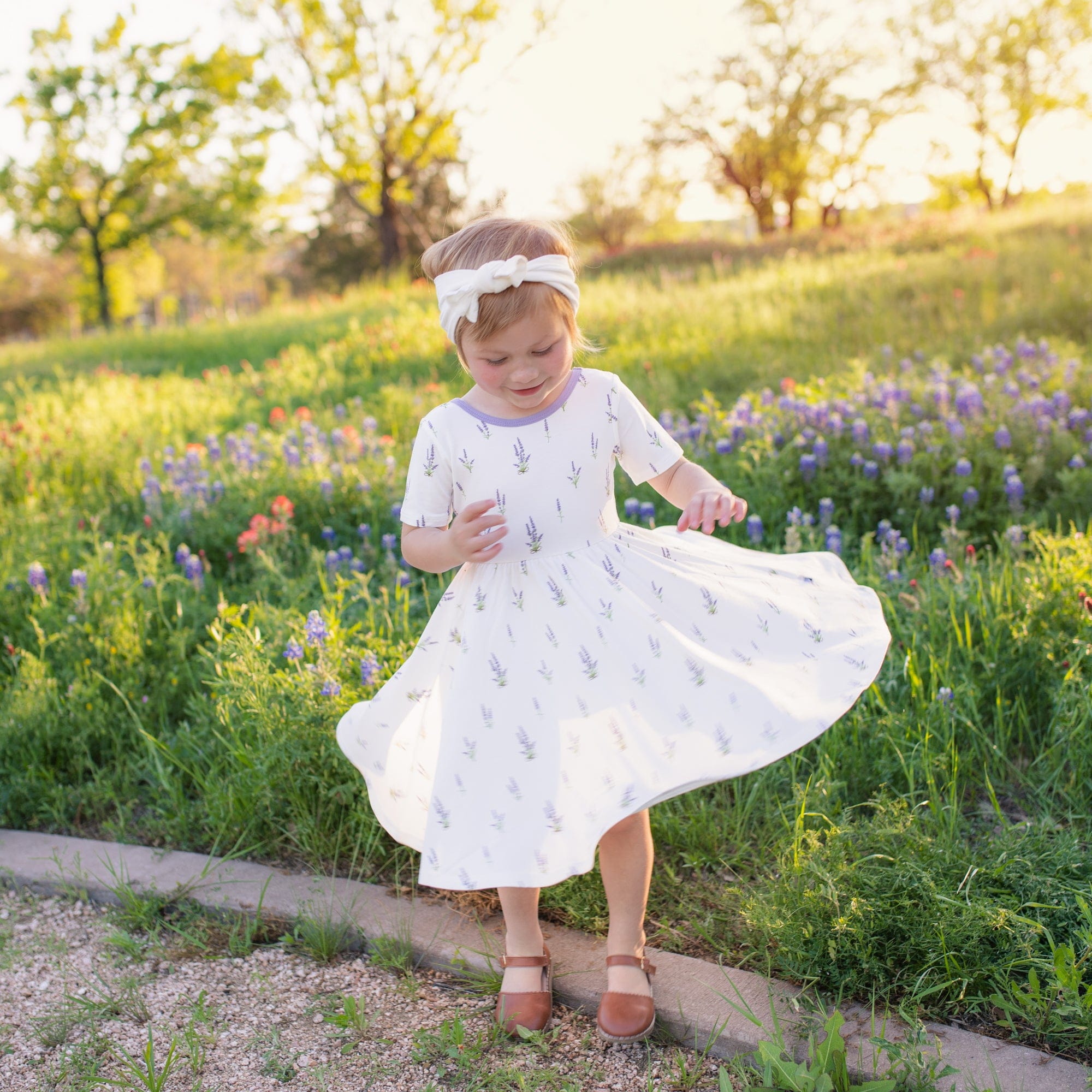 Toddler wearing Kyte Baby Twirl Dress in Lavender