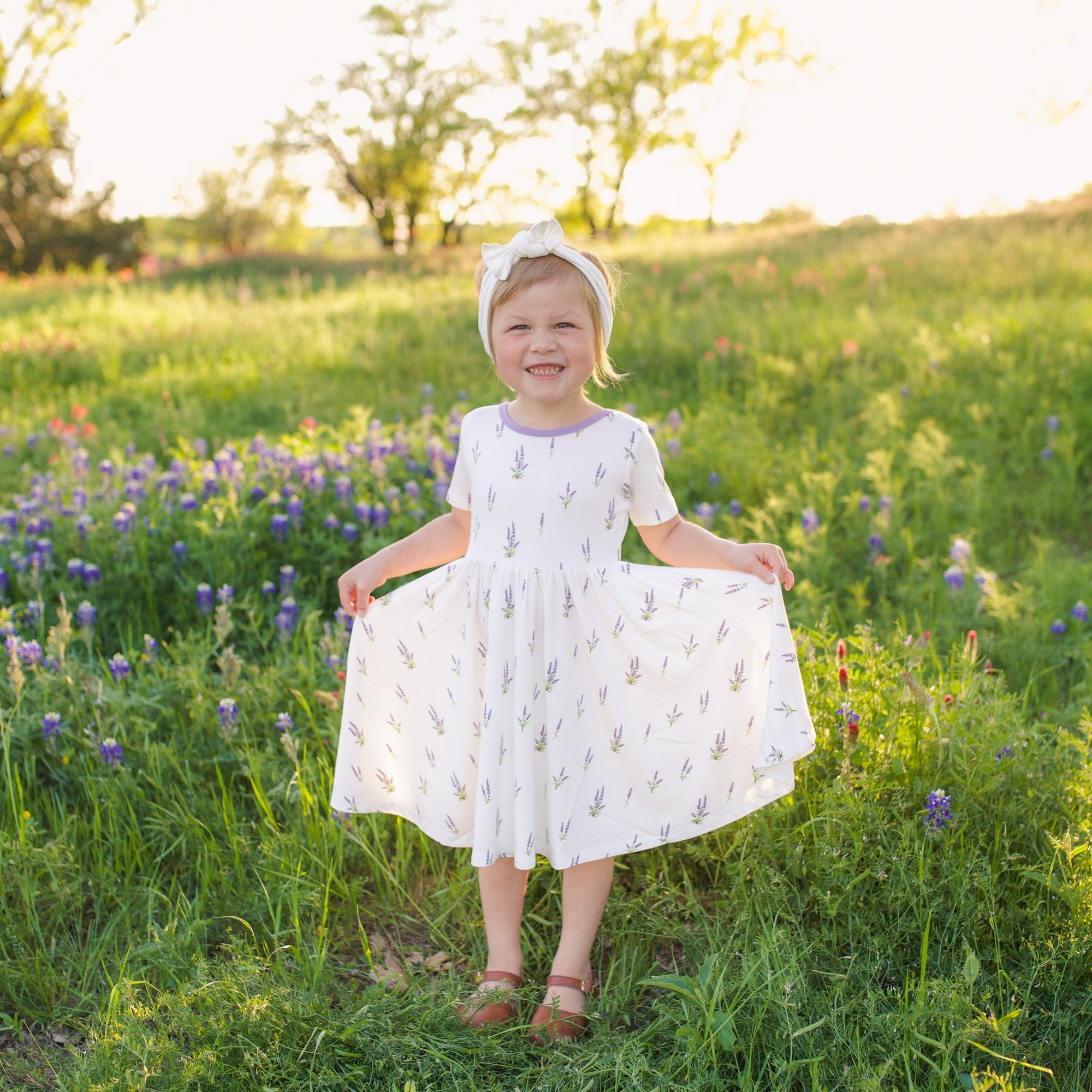 Girl wearing Kyte Baby Twirl Dress in Lavender