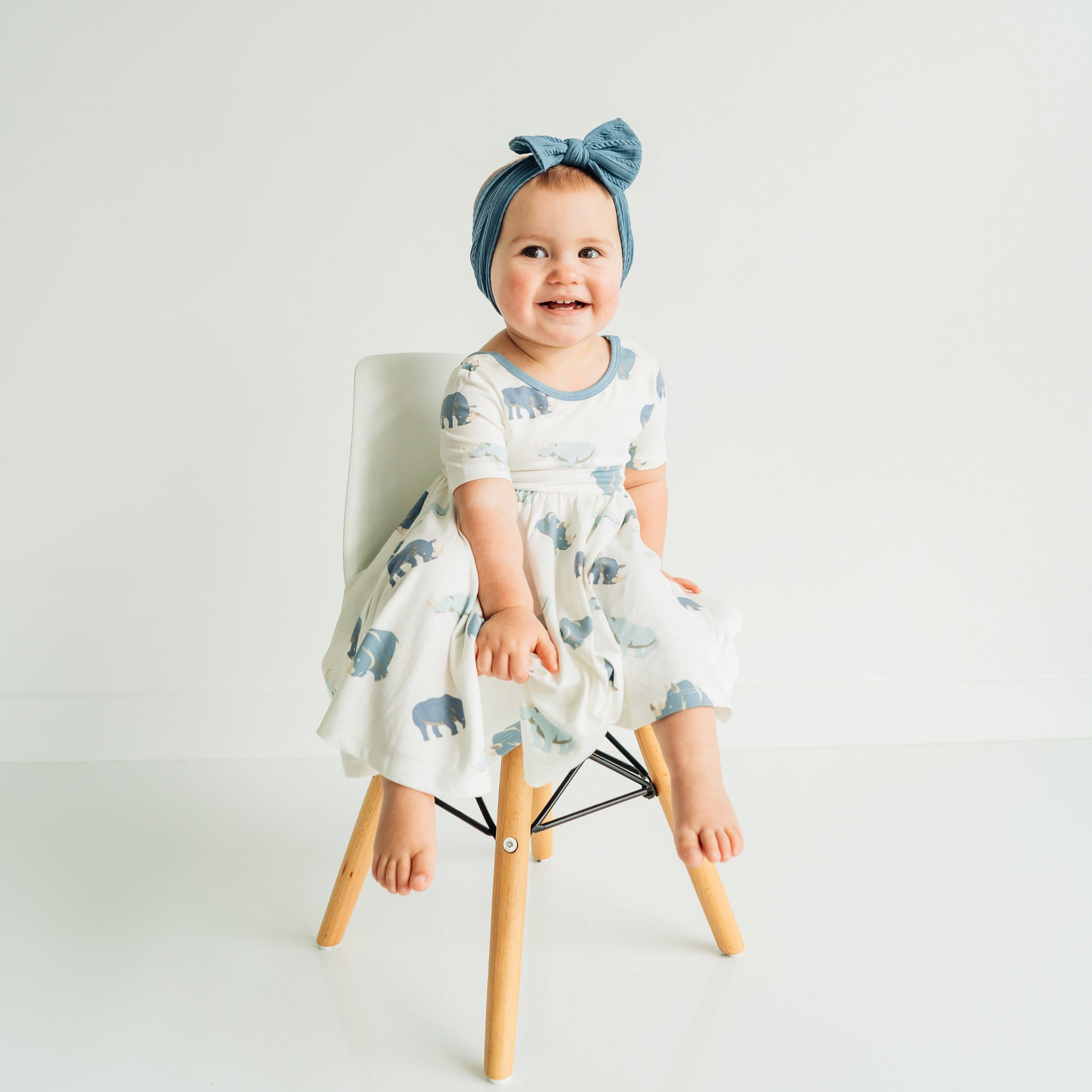 Toddler wearing Kyte Baby Twirl Dress in Rhino