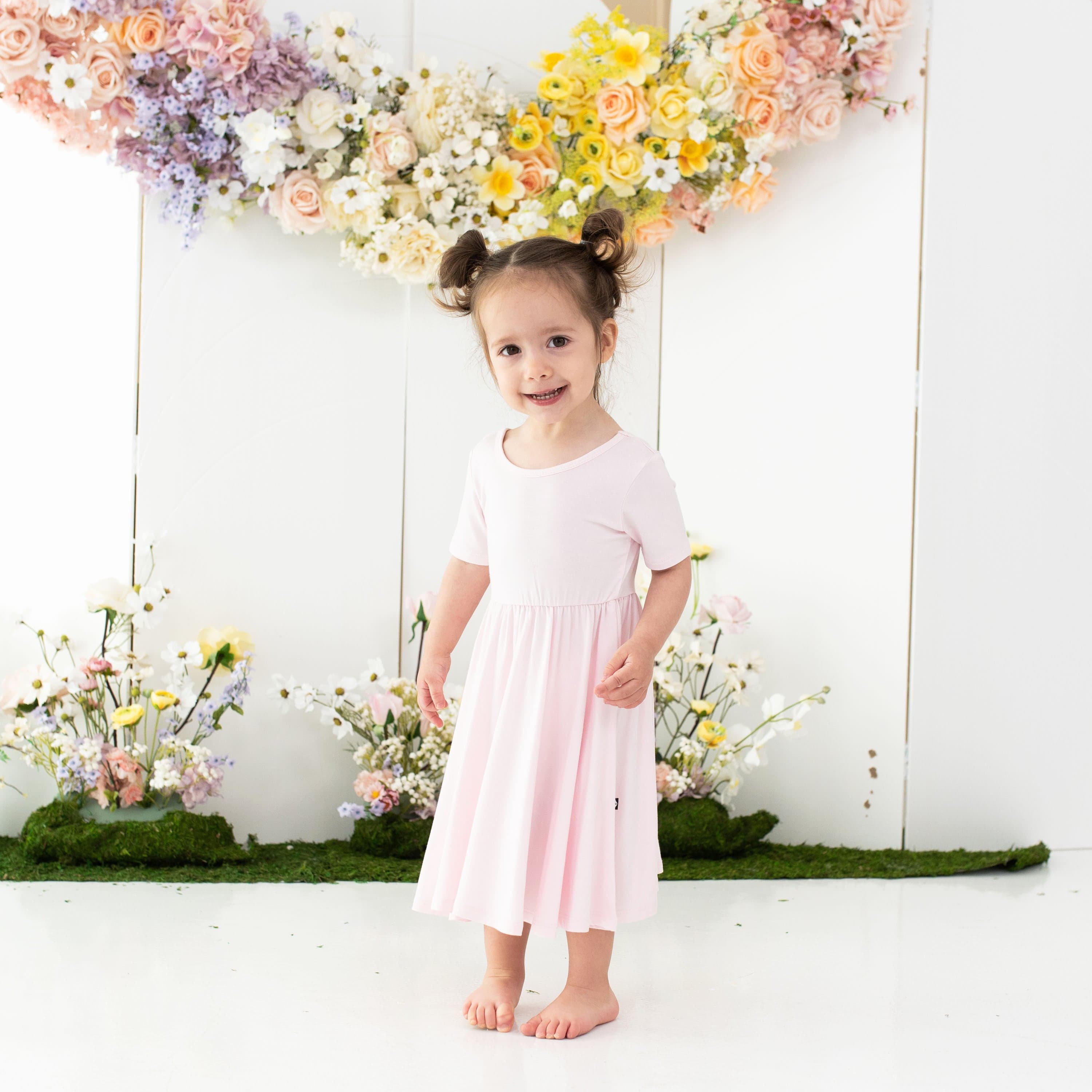 Girl wearing Kyte Baby Twirl Dress in Sakura
