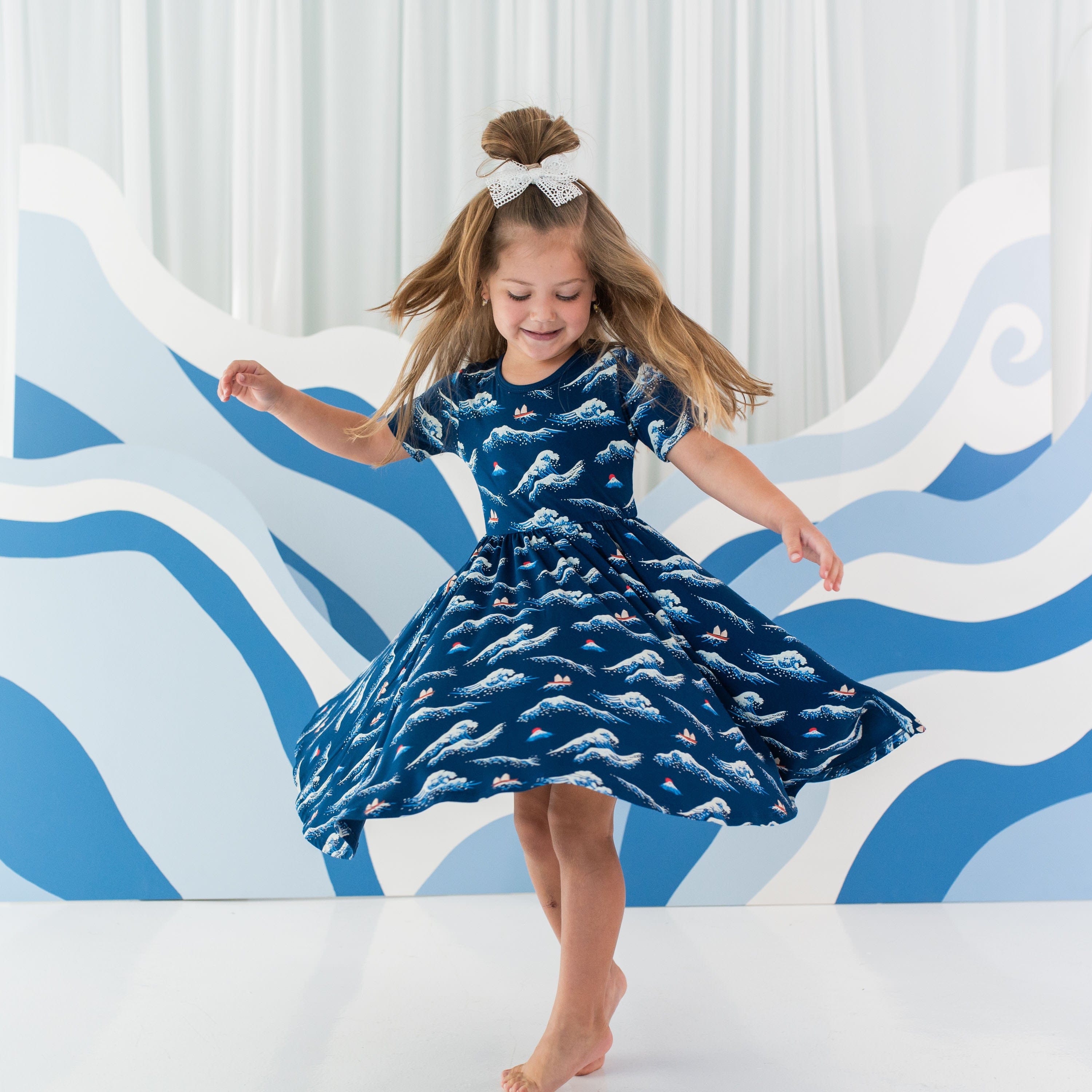 Toddler wearing Kyte Baby Twirl Dress in Wave