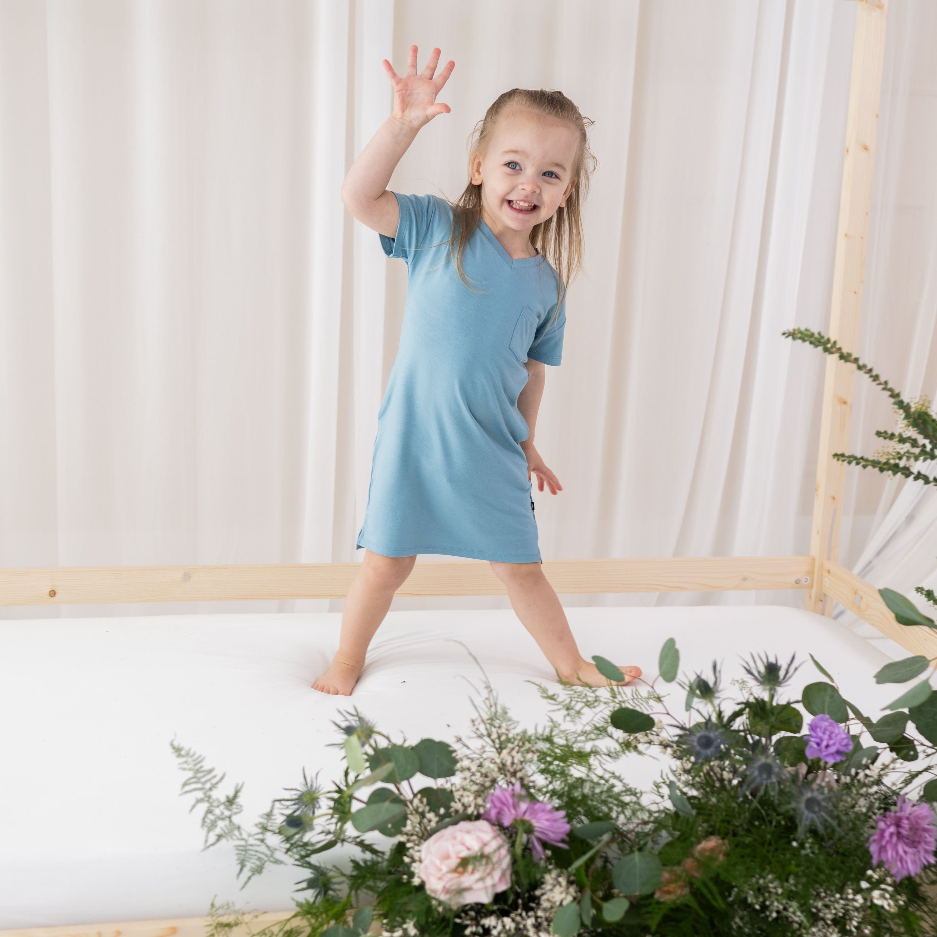 Toddler wearing Kyte Baby bamboo short sleeve T-Shirt Dress in Dusty Blue
