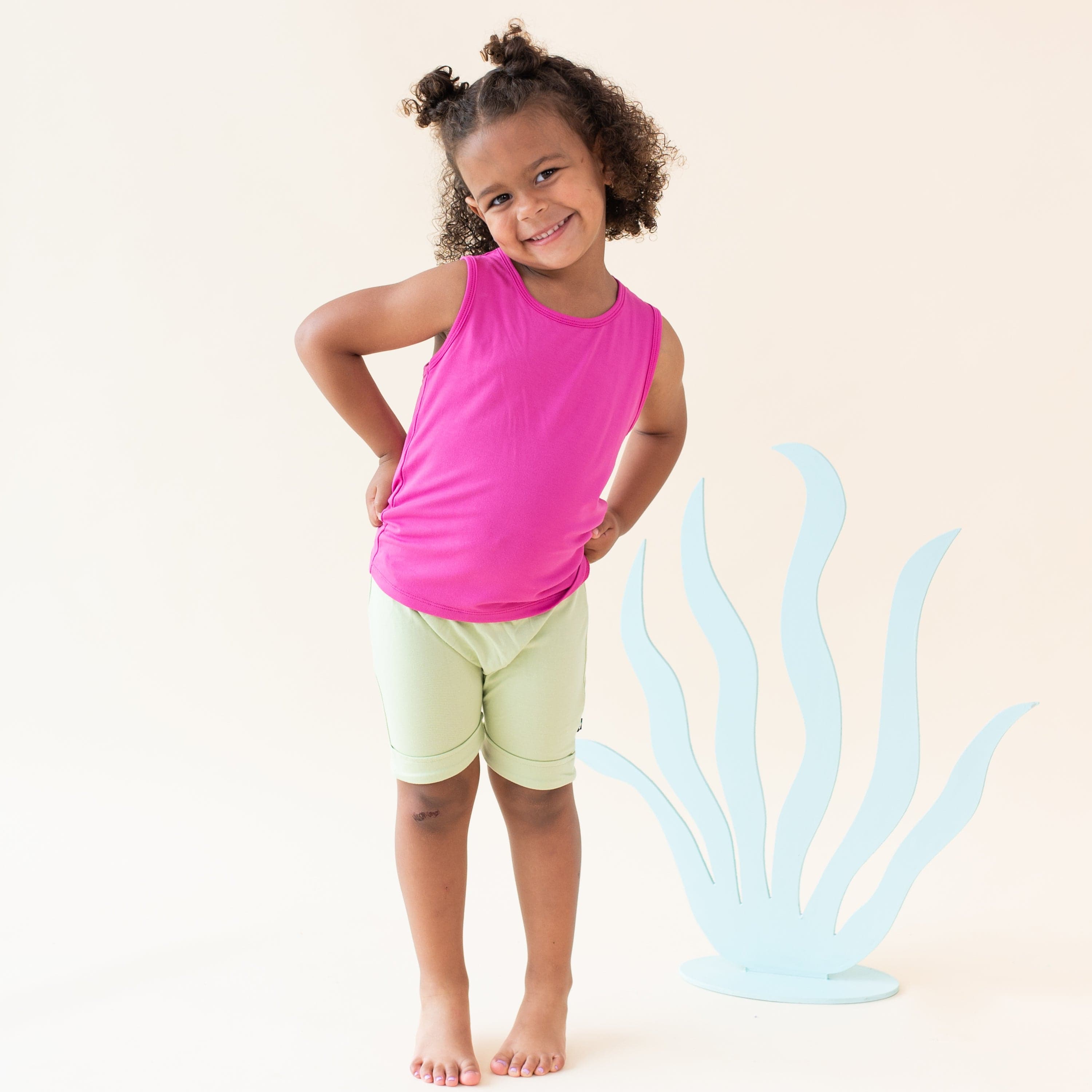 Girl wearing Kyte Baby Toddler Tank Top in Raspberry
