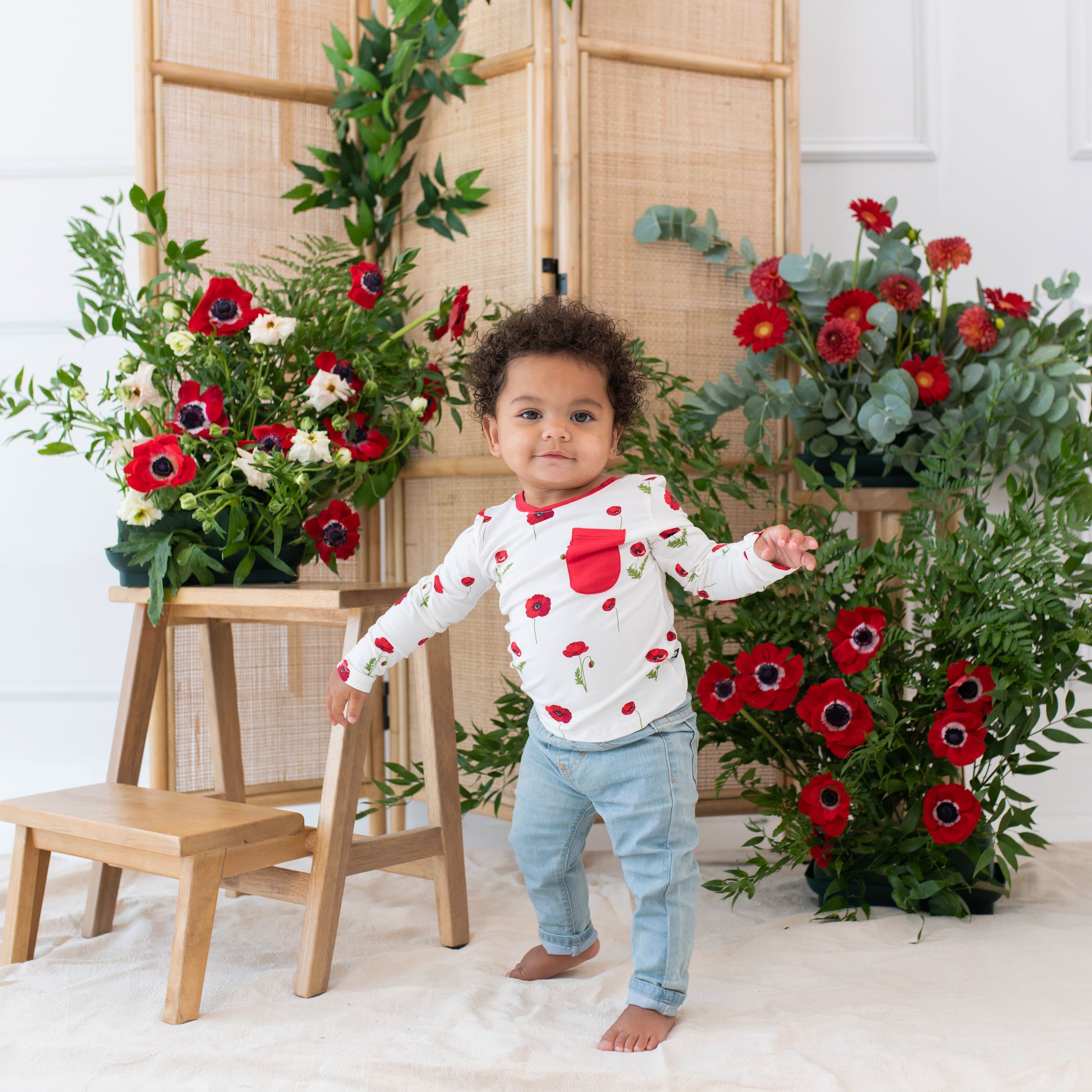 Toddler wearing Kyte Baby Long Sleeve Crew Neck Tee with pocket in Cloud Poppies