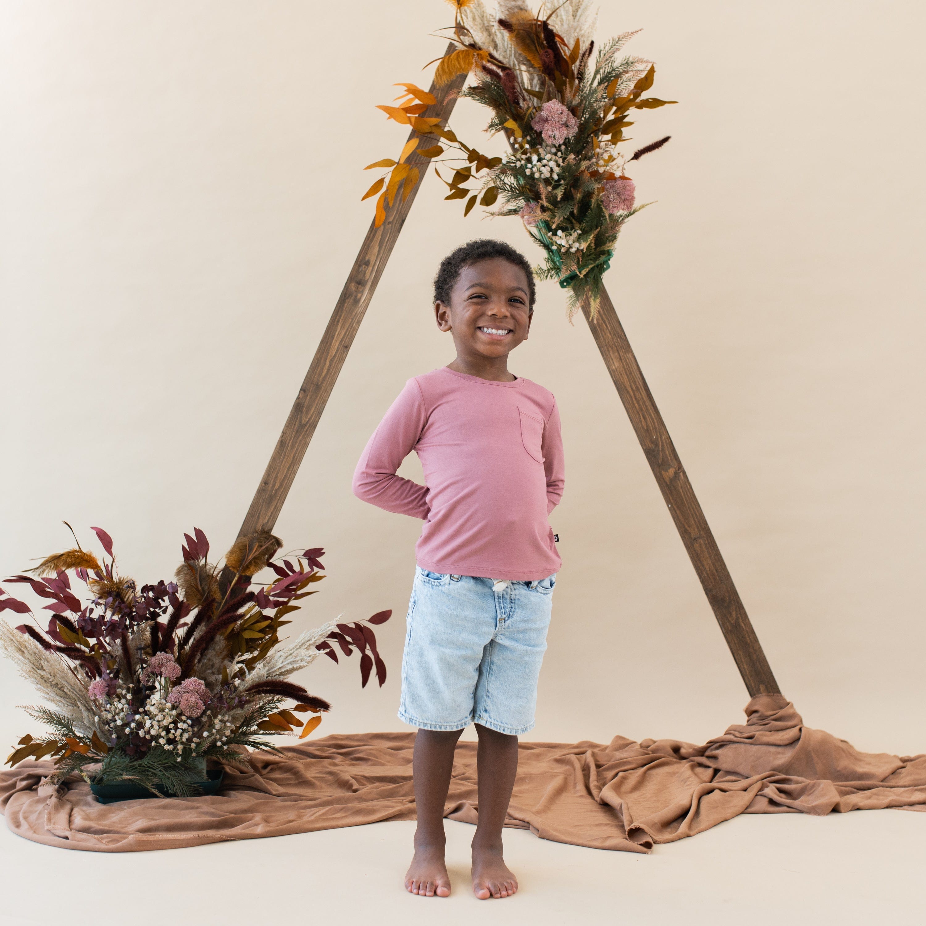 Child wearing Kyte Baby bamboo Long Sleeve Crew Neck Tee in Dusty Rose