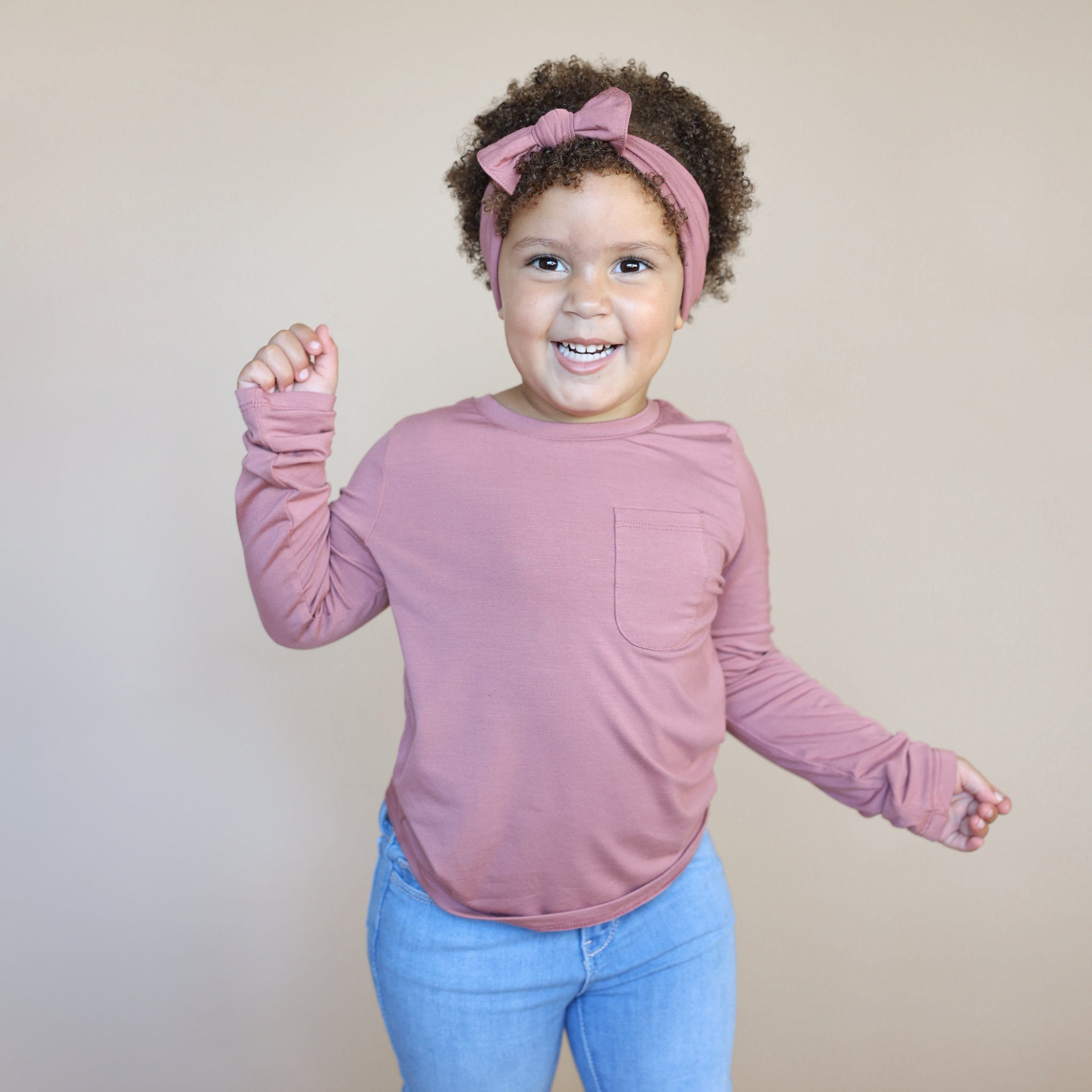 Toddler wearing Kyte Baby Long Sleeve Crew Neck Tee with pocket in Dusty Rose