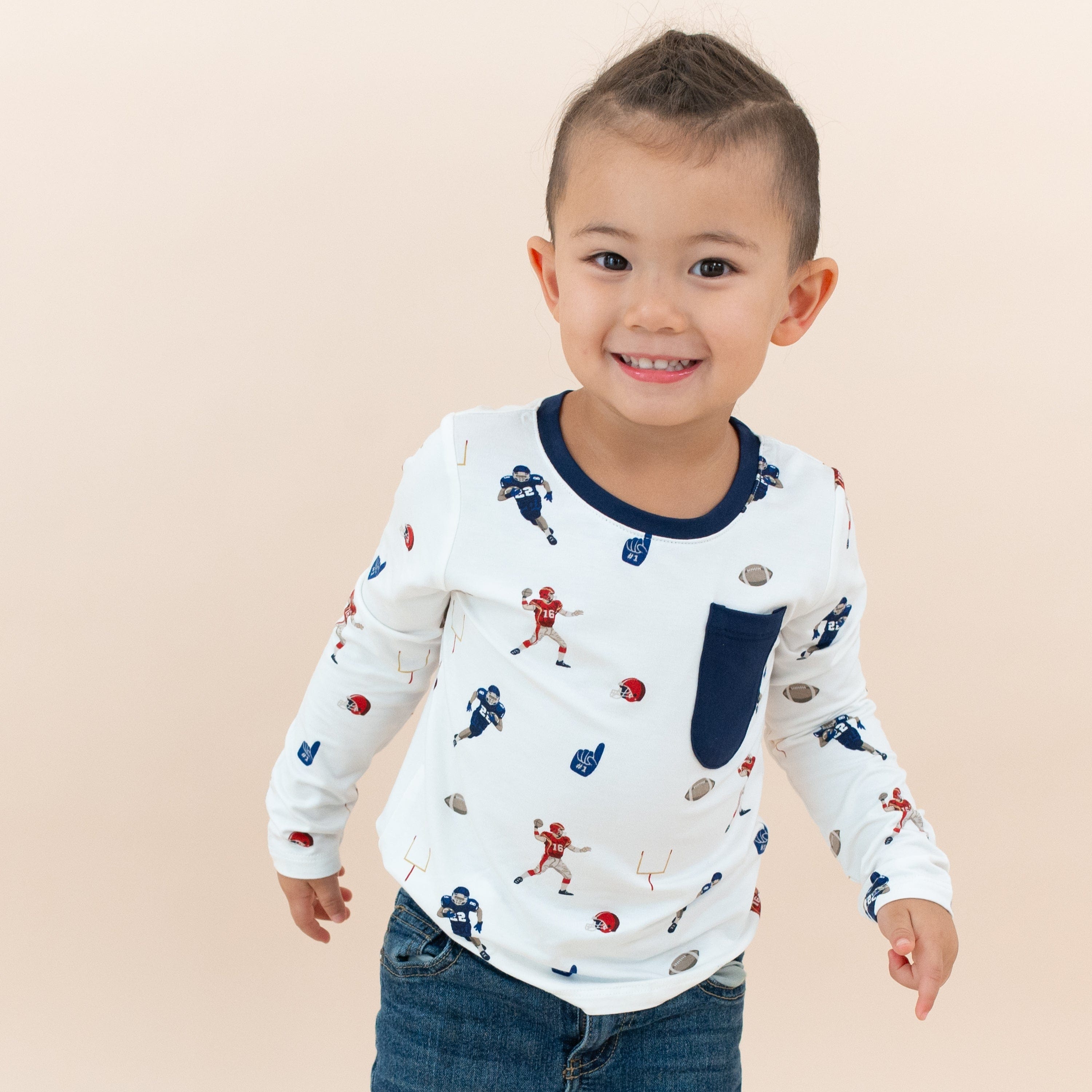 Toddler wearing Kyte Baby bamboo Long Sleeve Toddler Crew Neck Tee in Football